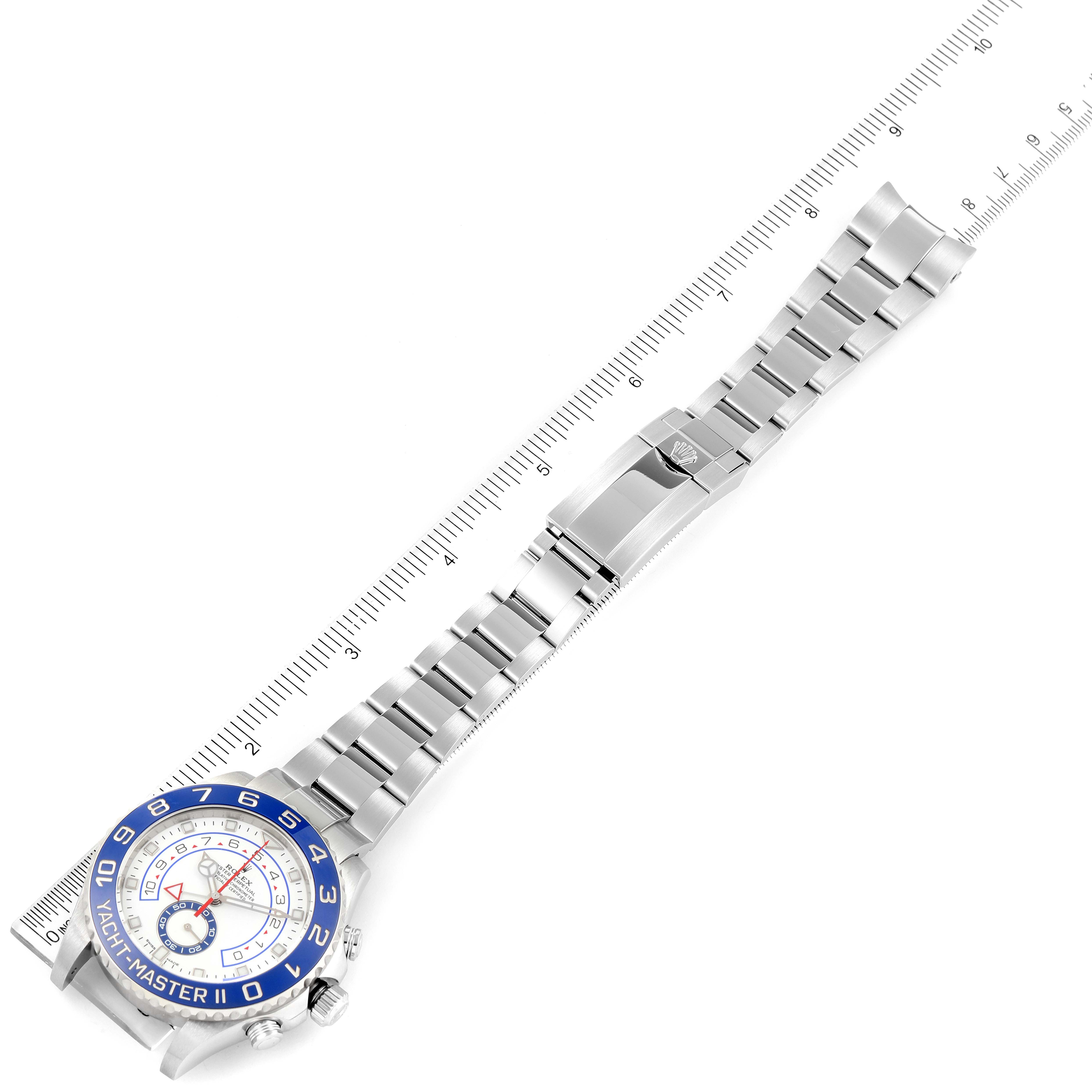 This image shows the Yacht-Master model by Rolex, laying flat with a ruler next to it, displaying the watch face, band, and clasp.