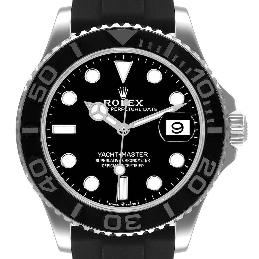 The Rolex Yacht-Master watch is shown from the front, highlighting the black dial, bezel, date window, and rubber strap.