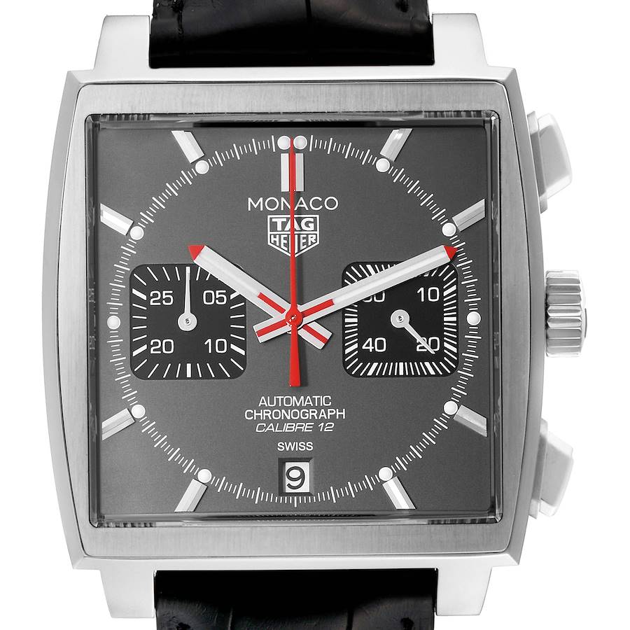 The Tag Heuer Monaco watch is shown from a front angle, displaying its square face, chronograph dials, hands, and crown.