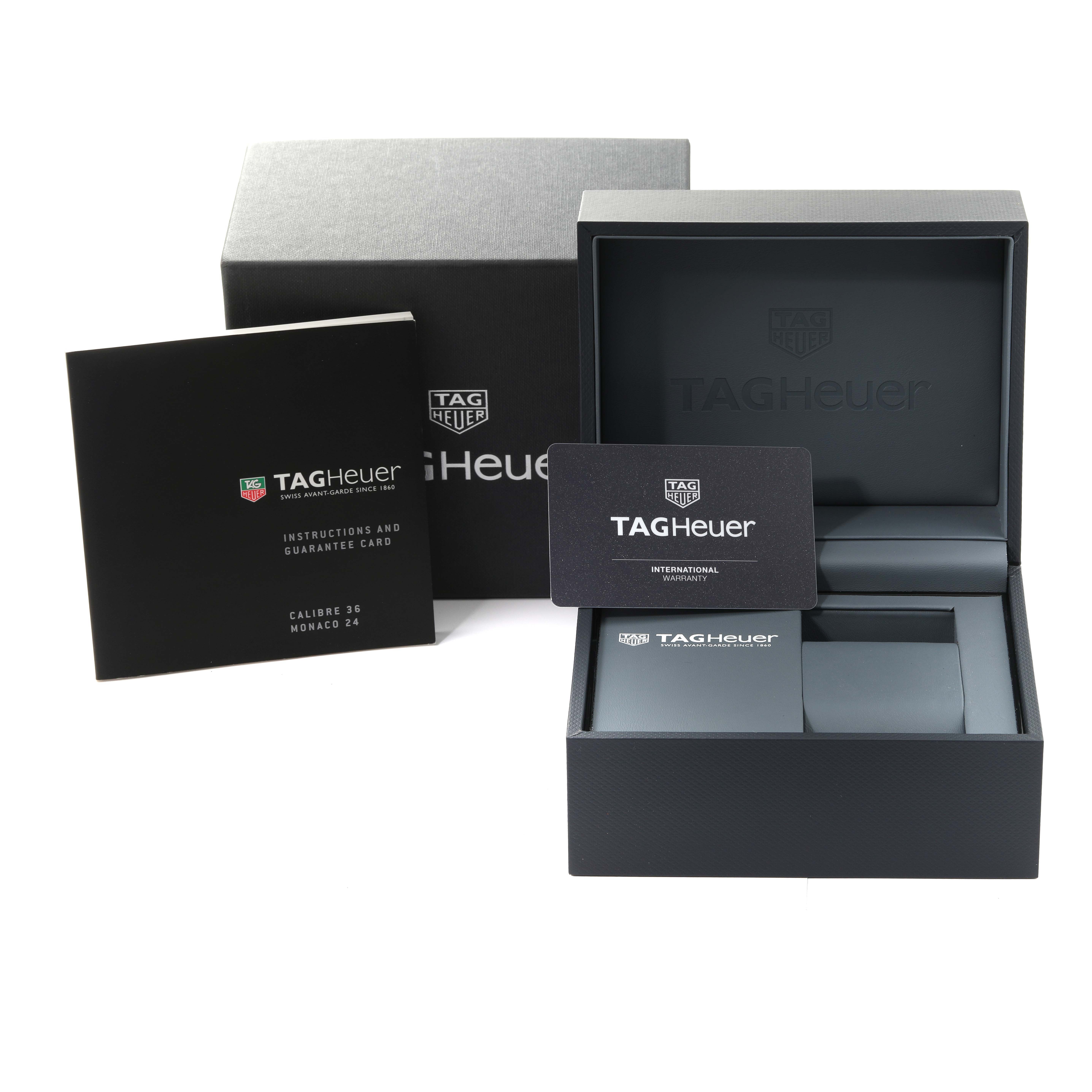 The image shows the box, instructions, and guarantee card for the Tag Heuer Monaco CAW211J.FC6476 Men
s Stainless Steel Grey Dial CAW211J.FC6476 Men
s Stainless Steel Grey Dial model watch from a front angle.