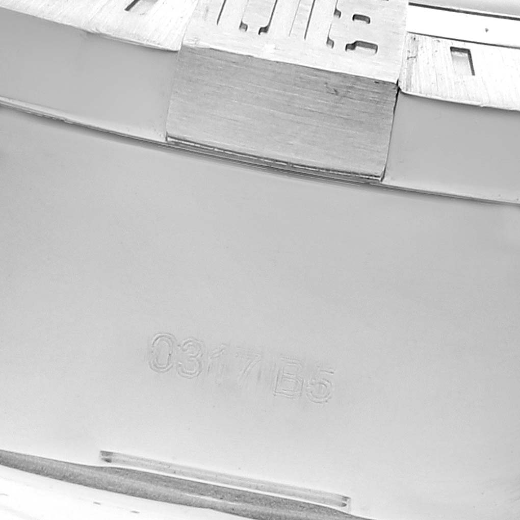 This image shows a close-up of the serial number and part of the bezel of a Breitling Avenger A13371 Men's Stainless Steel Black Dial A13371 Men's Stainless Steel Black Dial watch.