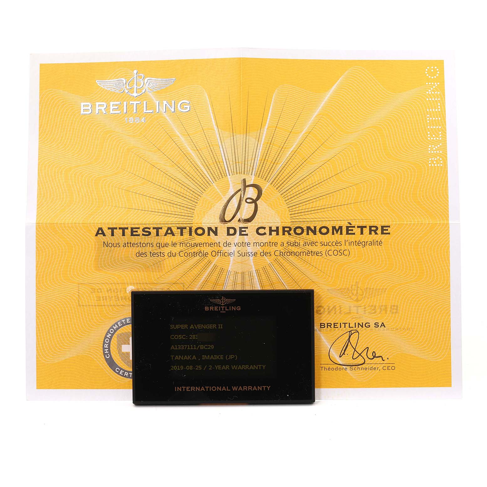 The image shows a Breitling Avenger A13371 Men's Stainless Steel Black Dial A13371 Men's Stainless Steel Black Dial warranty card and certificate of chronometer authenticity from a top-down angle.