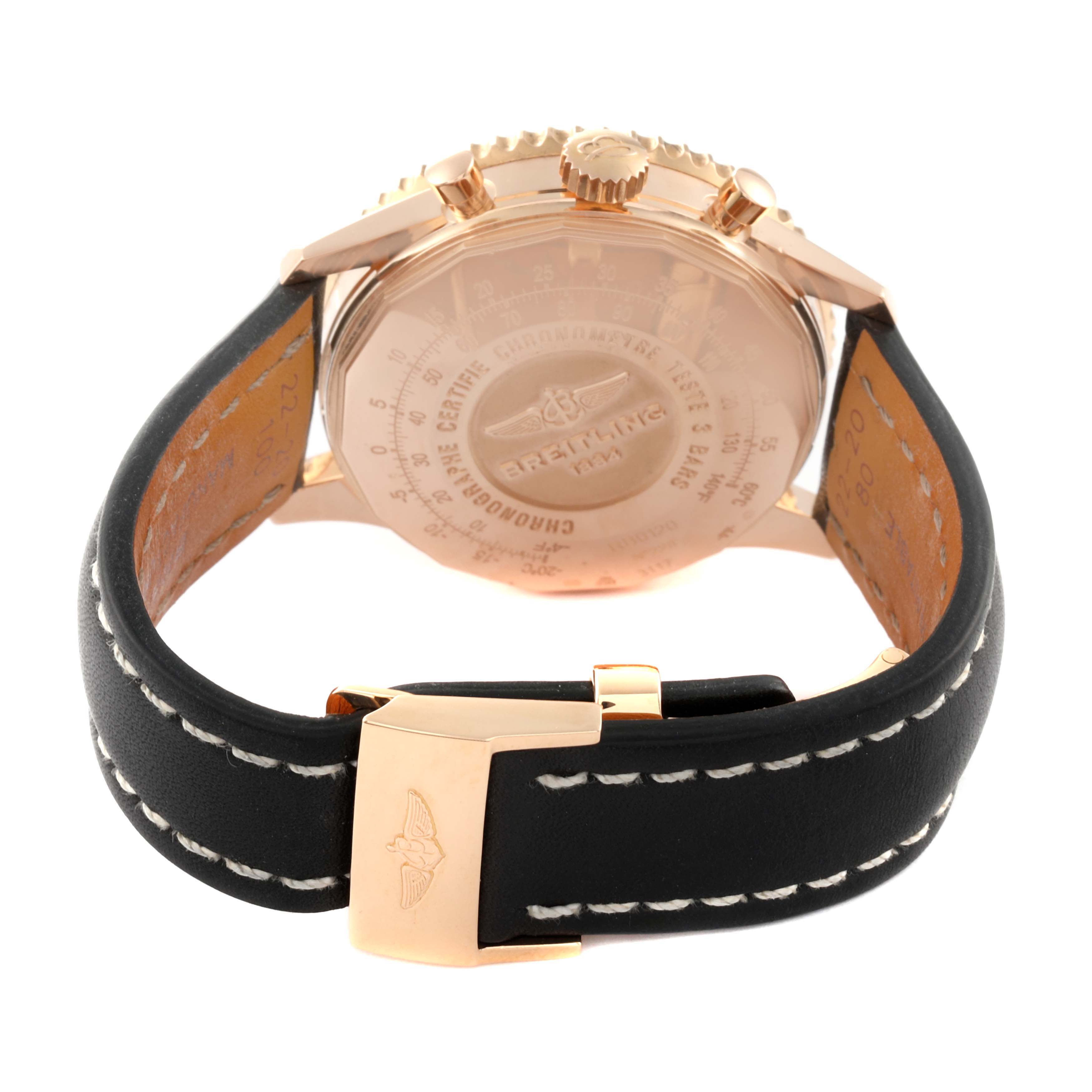 This image shows the back side of a Breitling Navitimer RB0120 Men
s Rose Gold Black Dial RB0120 Men
s Rose Gold Black Dial watch with a black leather strap and gold clasp.