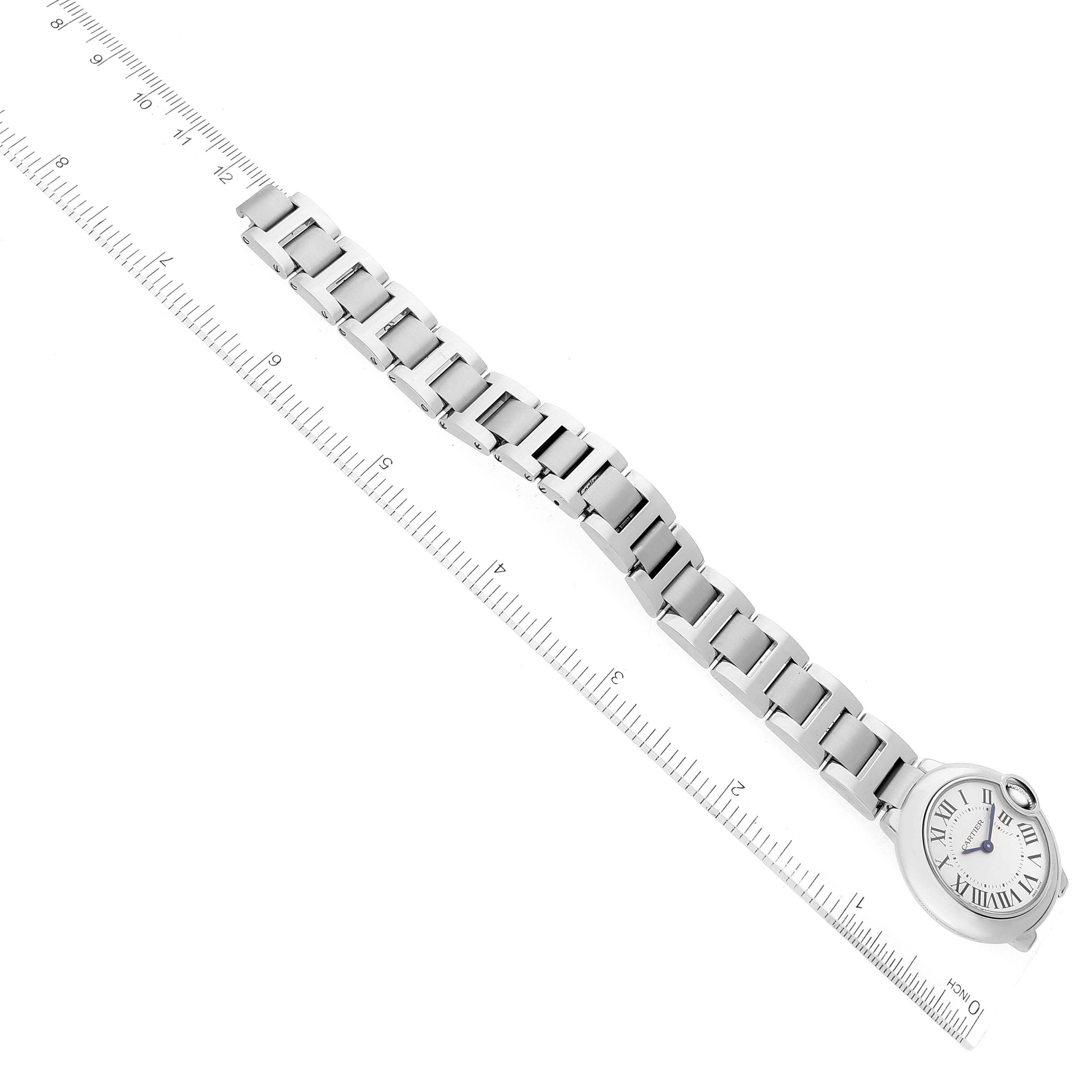 This image shows a Ballon Bleu de Cartier watch laying flat with its stainless steel bracelet and face visible, measured against a ruler.
