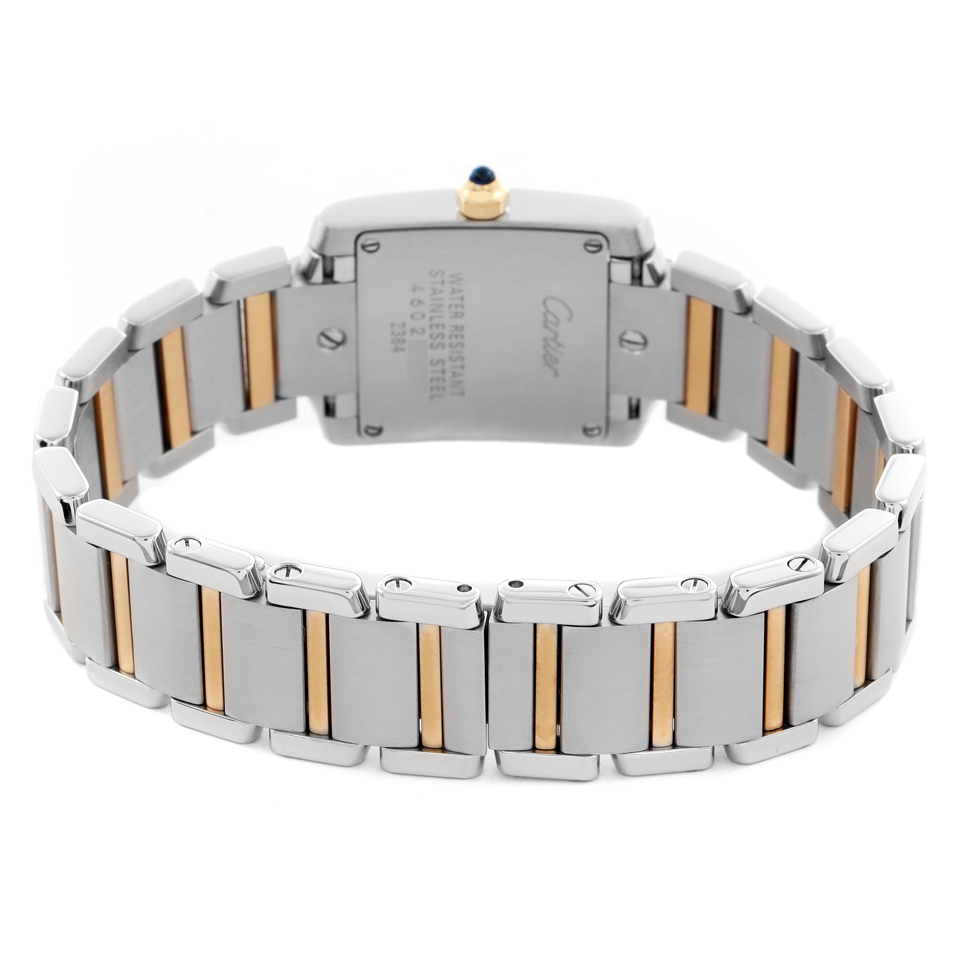 The Cartier Tank Française watch is shown from the back, highlighting the bracelet and case back details.