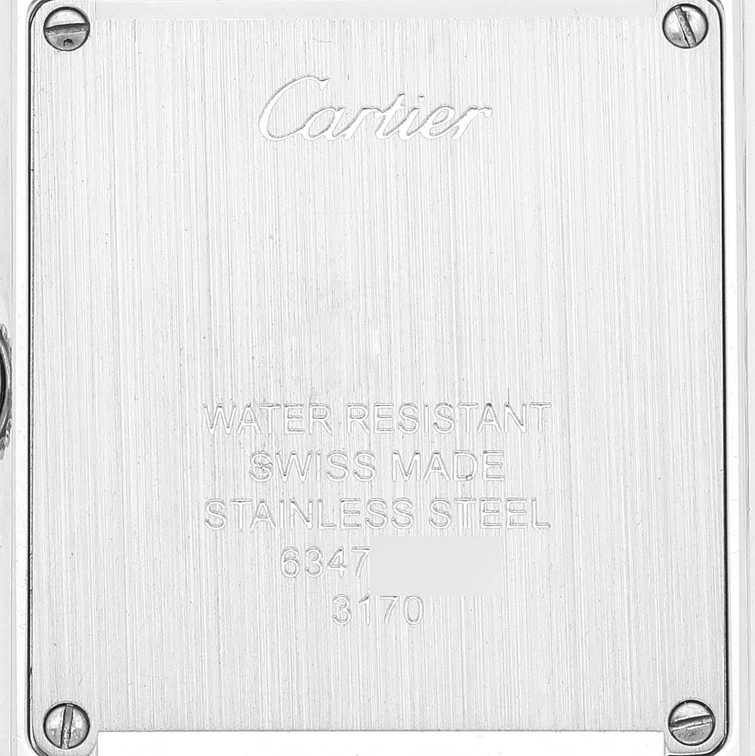 The image shows the back casing of a Tank Solo model watch by Cartier, highlighting its engravings and screws.