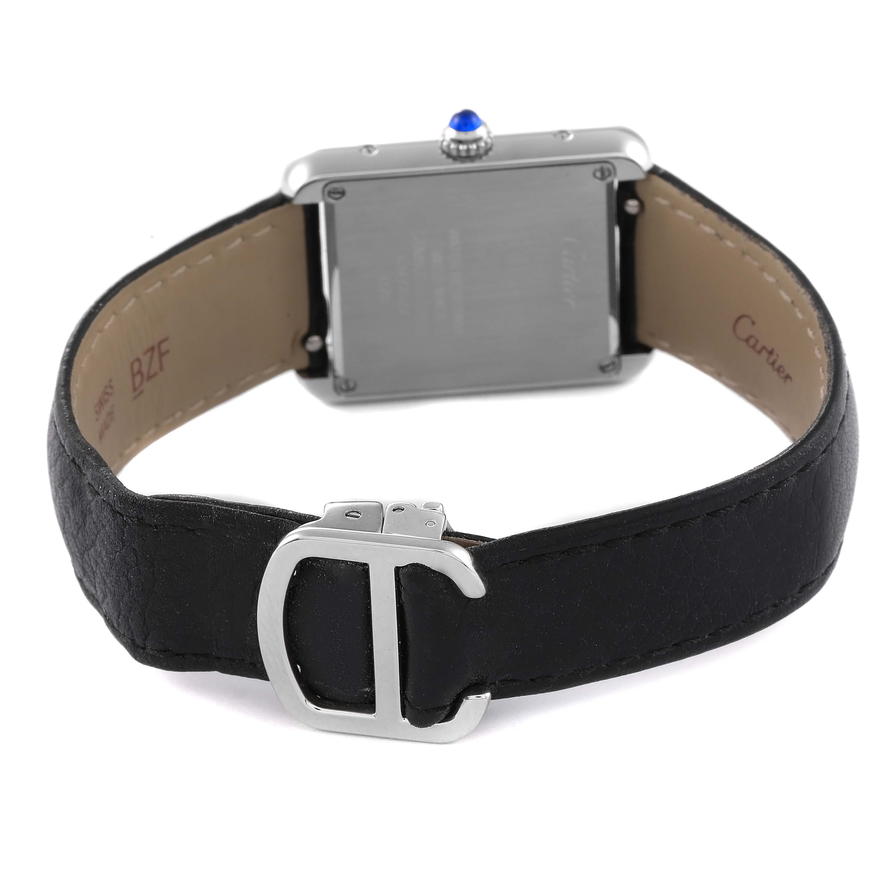 The image shows the back view of a Cartier Tank Solo WSTA0030 Women
s Stainless Steel Silver Dial WSTA0030 Women
s Stainless Steel Silver Dial watch, featuring its case back, crown with a blue cabochon, and black leather strap with a metal clasp.