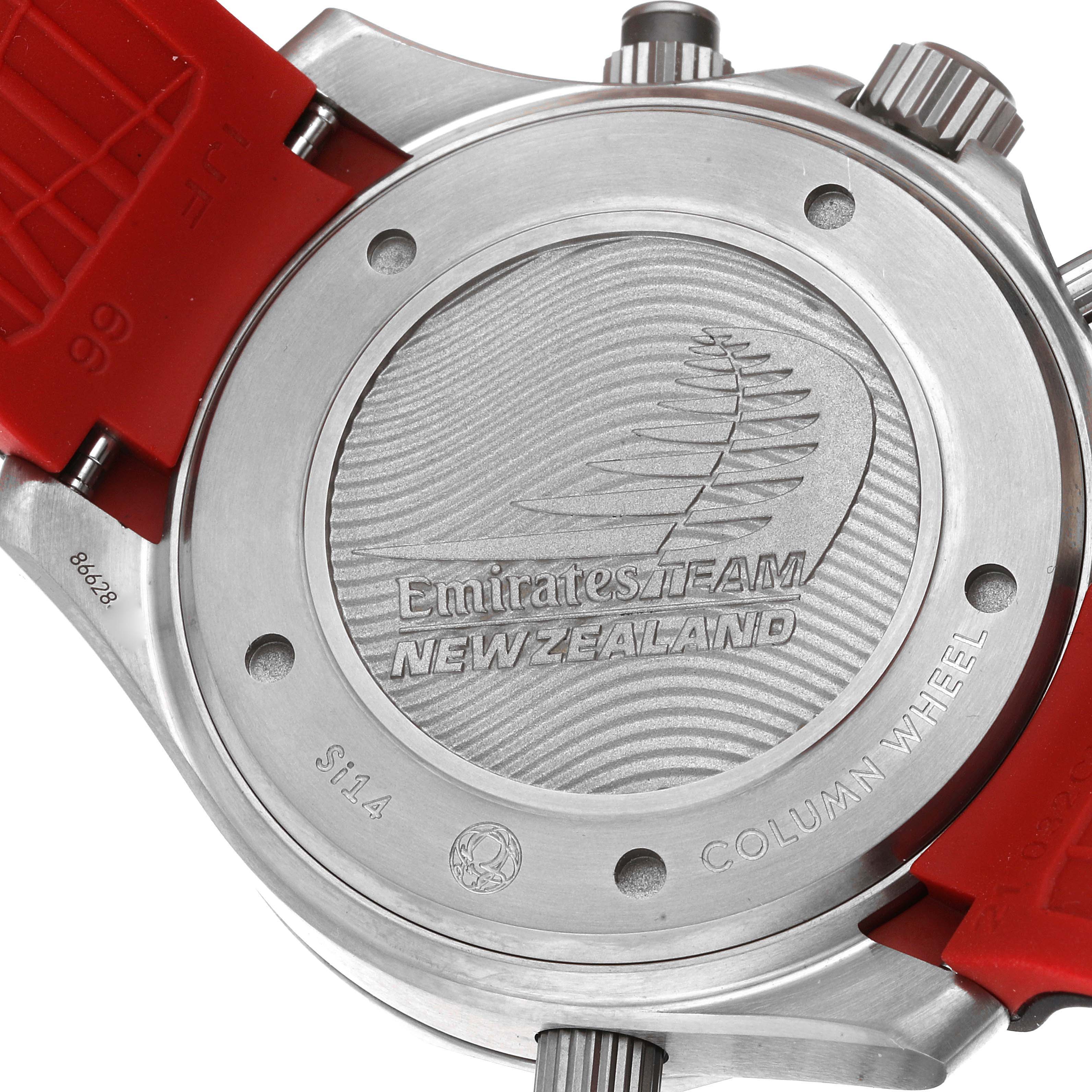 The image shows the back case and red strap of the Omega Seamaster 212.92.44.50.99.001 Men's Titanium Grey Dial 212.92.44.50.99.001 Men's Titanium Grey Dial watch, detailing the Emirates Team New Zealand engraving.