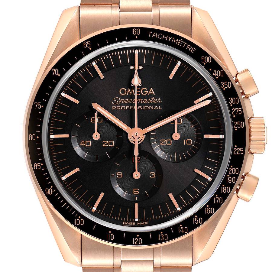 The Omega Speedmaster watch is shown from a front angle, highlighting the dial, tachymeter bezel, and chronograph subdials.