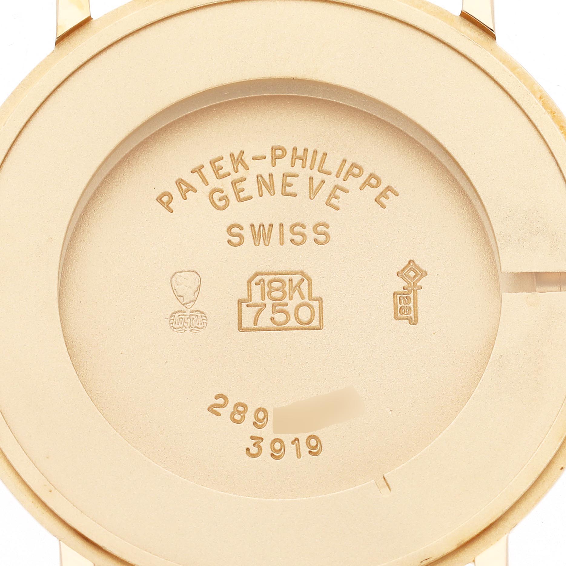 This image shows the back case of a Patek Philippe Calatrava 3919J-001 Men
s Yellow Gold White Dial 3919J-001 Men
s Yellow Gold White Dial watch, displaying engravings and marks.