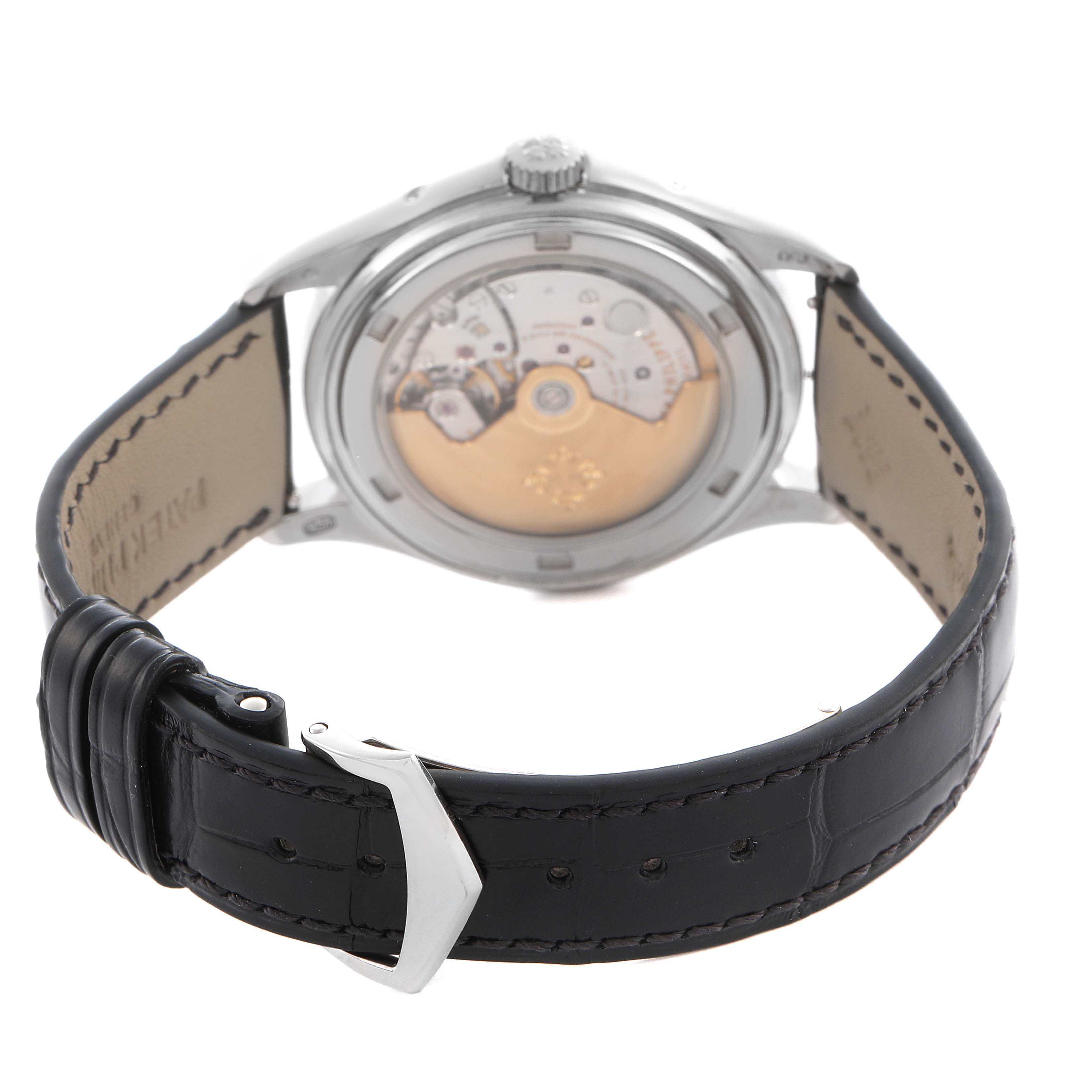 The image shows the back view of a Patek Philippe Complications 5146G Men
s White Gold White Dial 5146G Men
s White Gold White Dial watch, highlighting its movement and black leather strap.