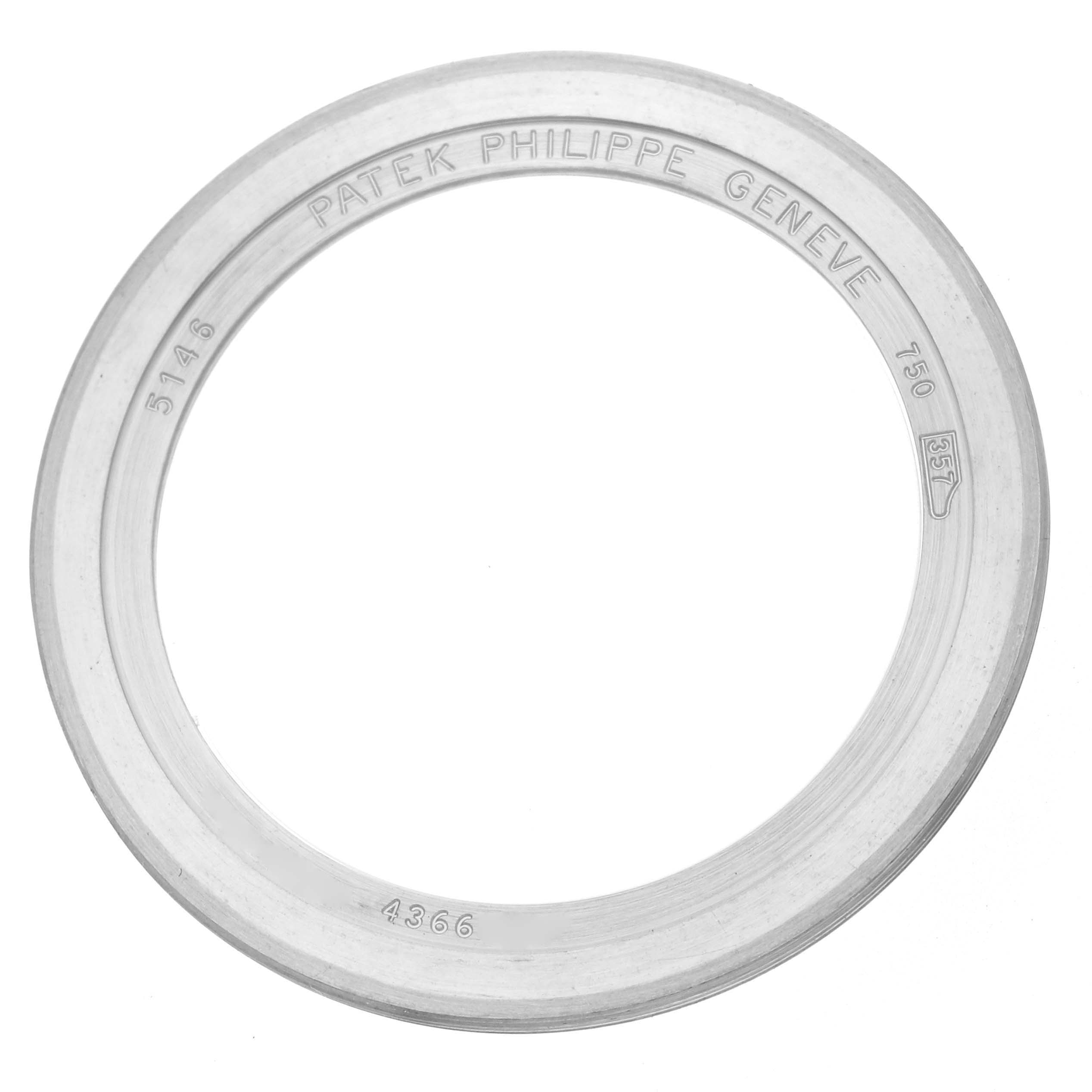 The image shows a top view of a Patek Philippe Complications 5146G Men
s White Gold White Dial 5146G Men
s White Gold White Dial model watch bezel with engraved markings.