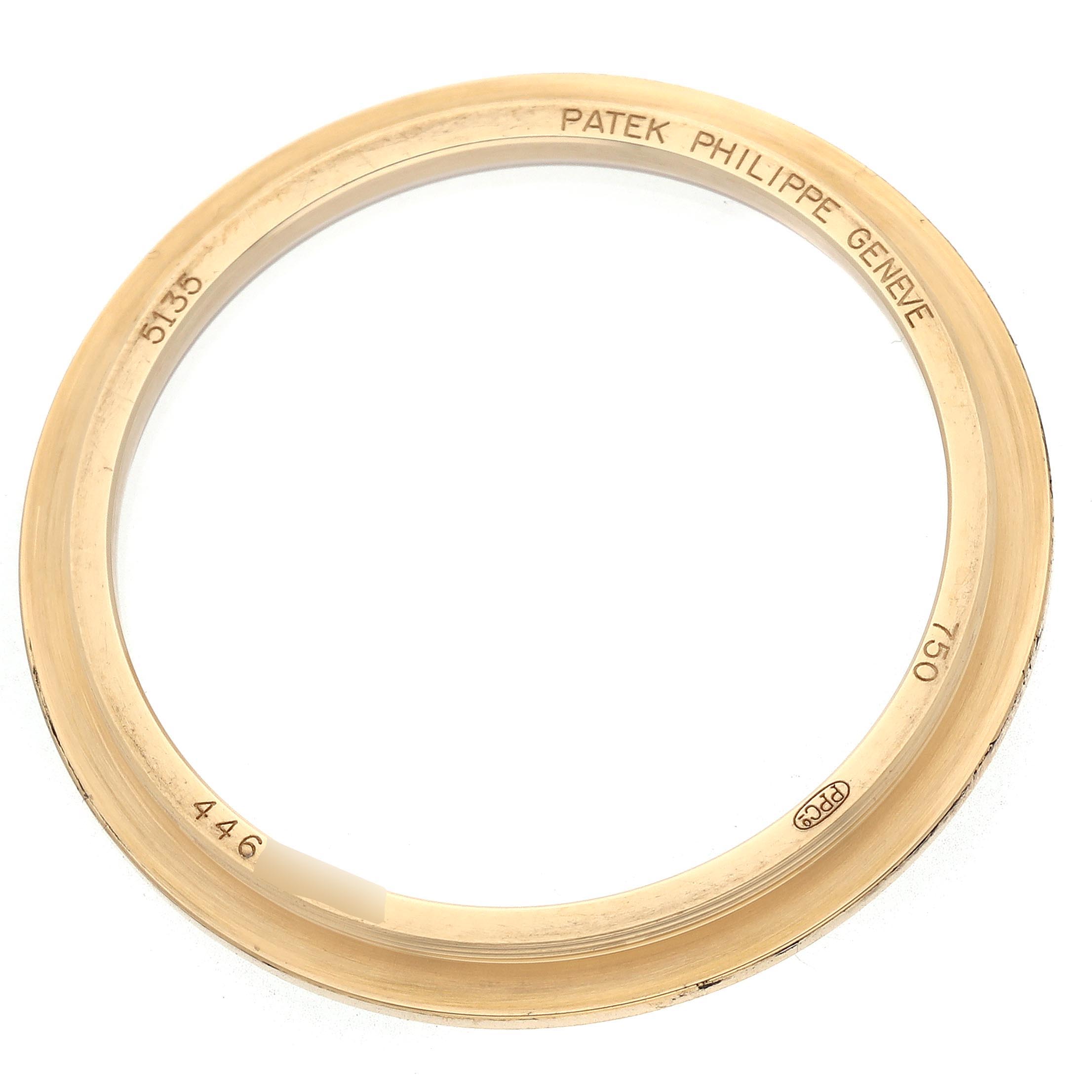 The image shows the bezel of a Patek Philippe Gondolo 5135J-001 Men
s Yellow Gold White Dial 5135J-001 Men
s Yellow Gold White Dial watch, viewed from above.