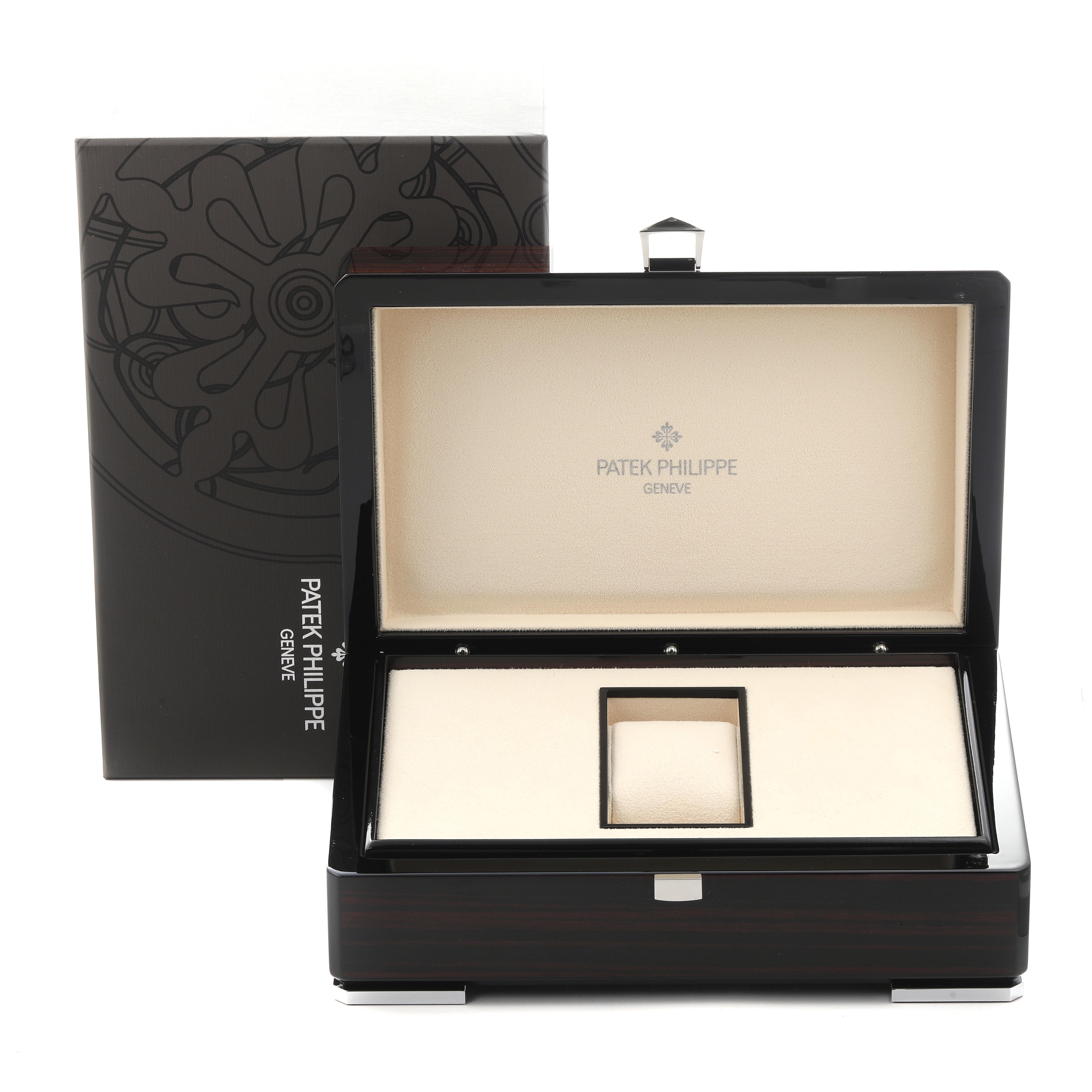 The image shows an open Patek Philippe Gondolo 5135J-001 Men
s Yellow Gold White Dial 5135J-001 Men
s Yellow Gold White Dial watch box with branding on the lid and an outer box in the background.