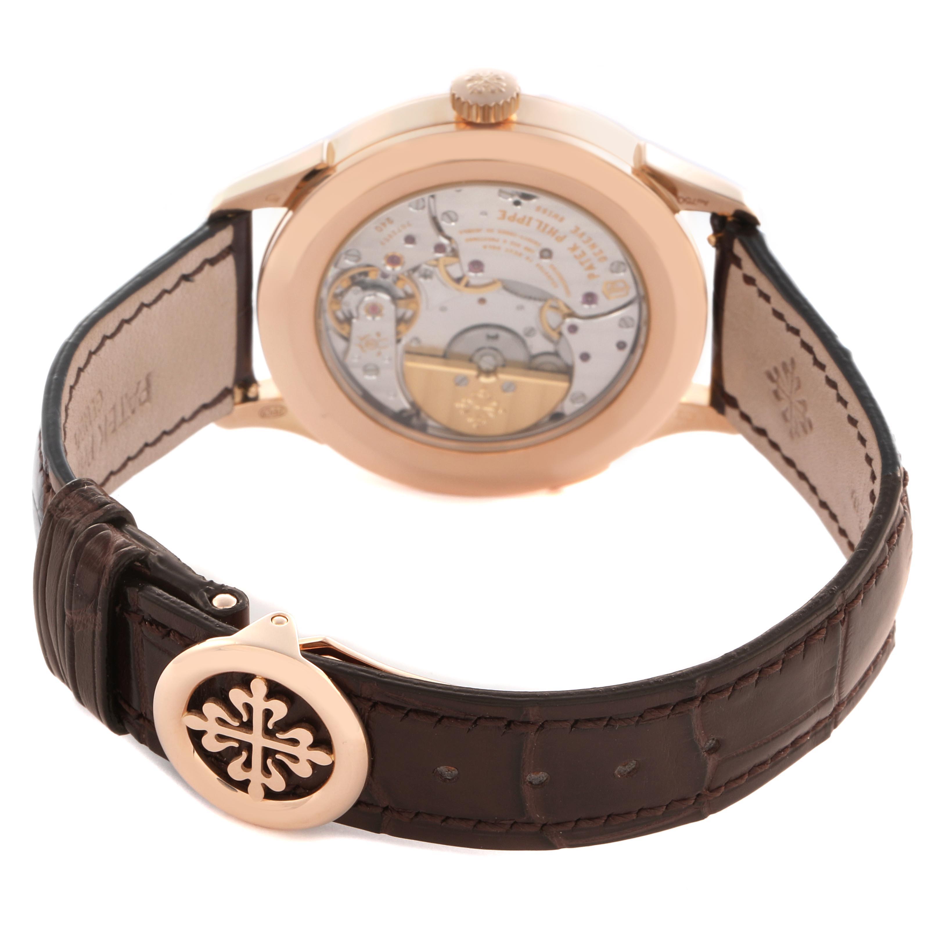 The Patek Philippe Complications 5230R-001 Men
s Rose Gold Grey Dial 5230R-001 Men
s Rose Gold Grey Dial watch is shown from the back, highlighting its open case back and leather strap.