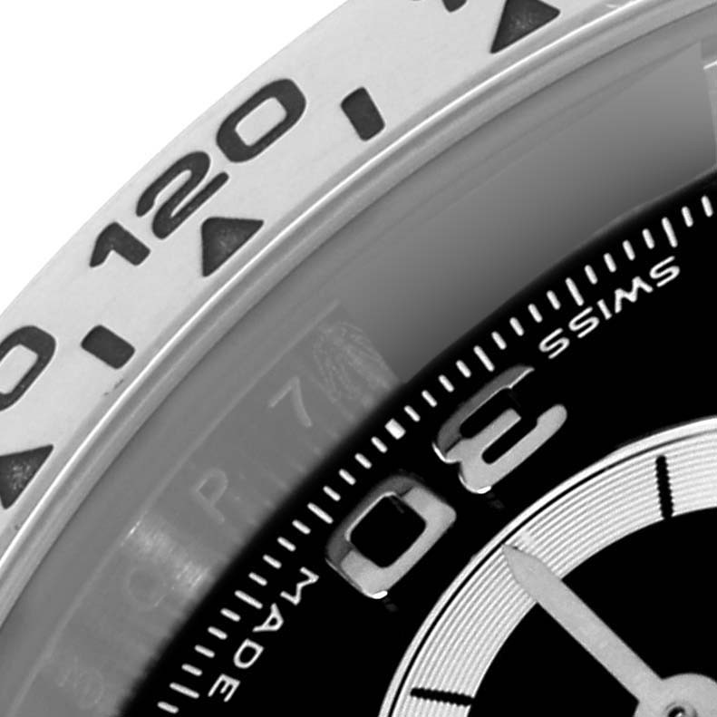 The image shows a close-up of the bezel and part of the dial of a Rolex Daytona 116509 Men
s White Gold Black Dial 116509 Men
s White Gold Black Dial watch.