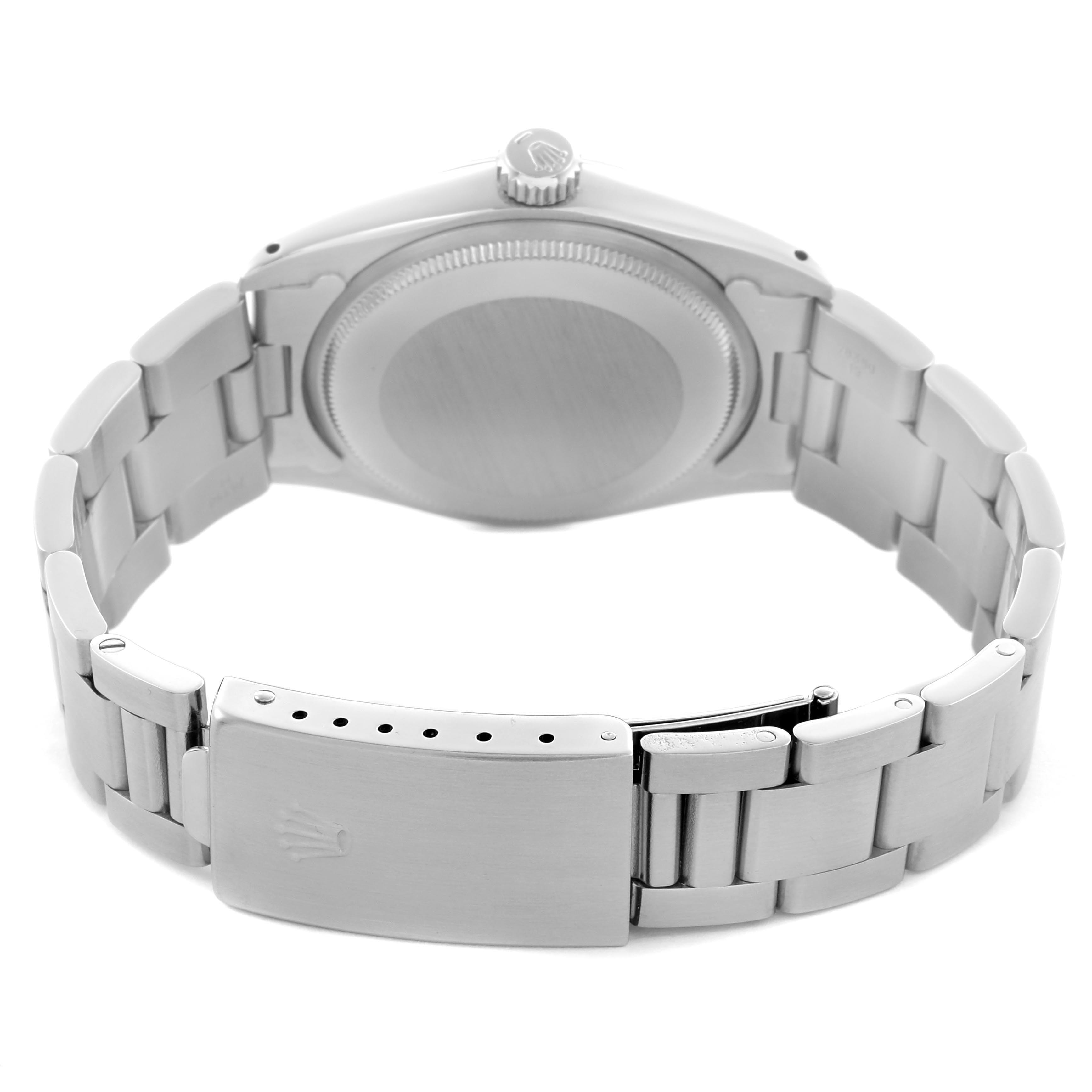 The Rolex Date model is shown from the back, highlighting the case back, crown, and bracelet clasp.