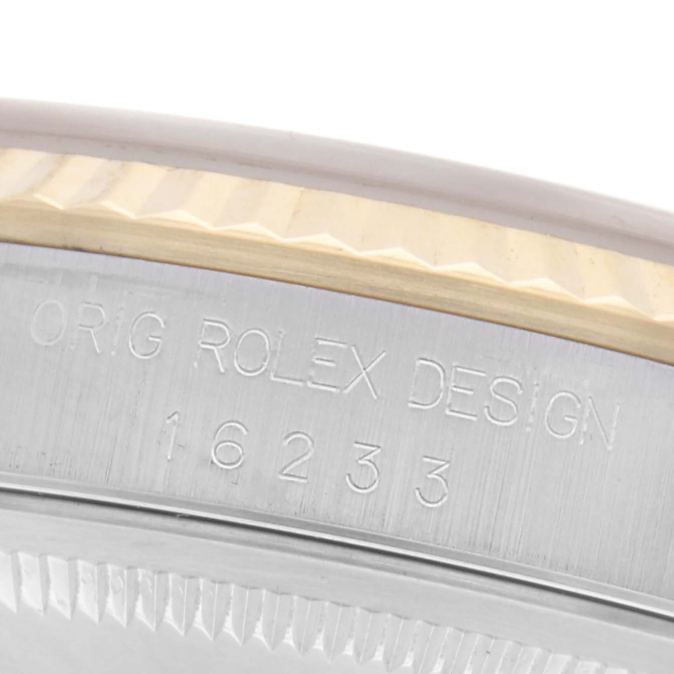 The image shows a close-up view of the side of a Rolex Datejust 16233 Men
s Steel and Gold (two tone) Champagne Dial 16233 Men
s Steel and Gold (two tone) Champagne Dial, highlighting the engraved model number and design markers.