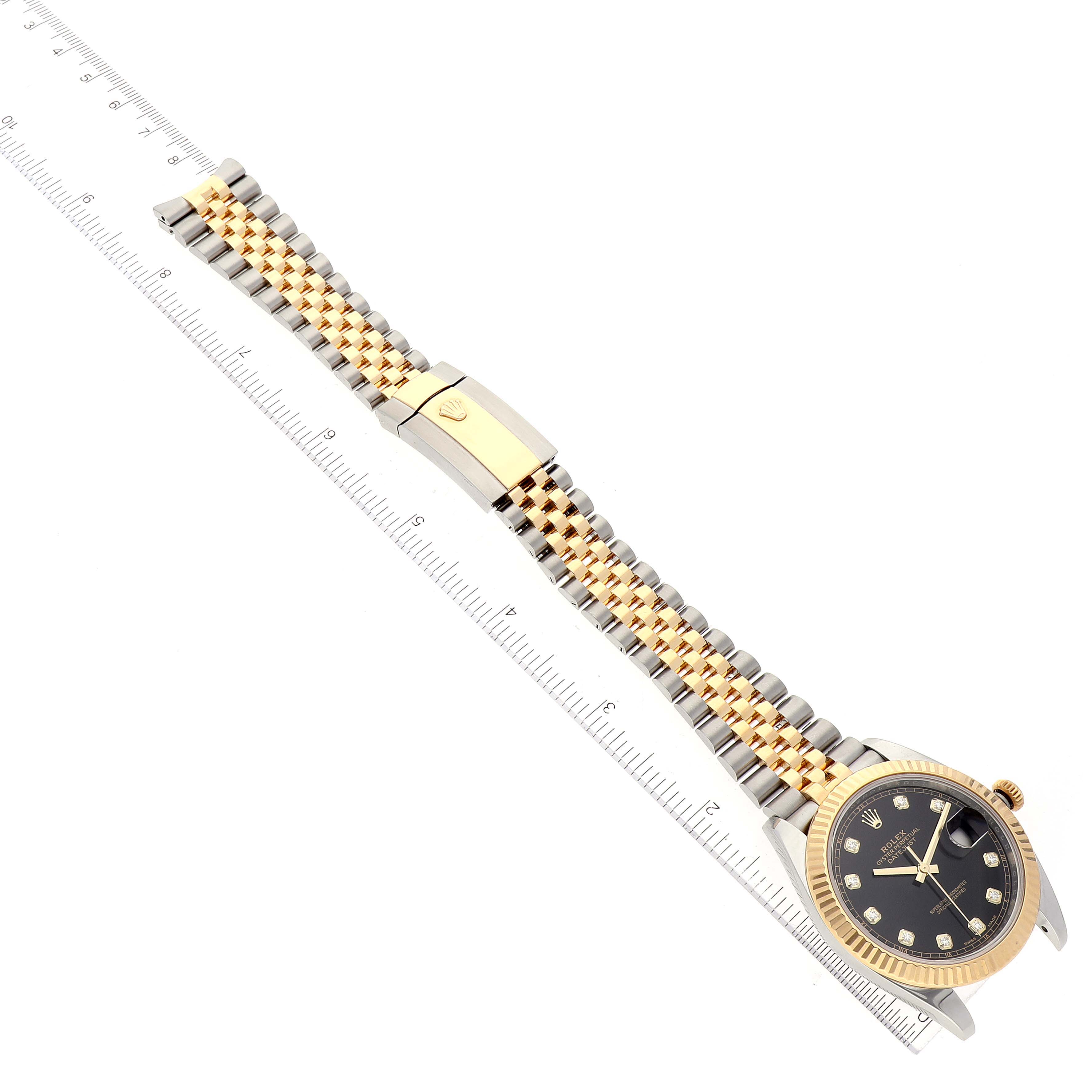 The image shows a Rolex Datejust 41 126333 Men's Steel and Gold (two tone) Black Dial 126333 Men's Steel and Gold (two tone) Black Dial watch from an angled top view displaying the full band and dial against a measuring ruler.