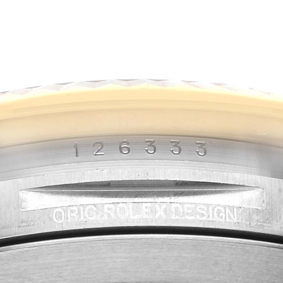 The image shows a close-up of the serial number and "ORIG ROLEX DESIGN" engraving on a Rolex Datejust 41 126333 Men's Steel and Gold (two tone) Black Dial 126333 Men's Steel and Gold (two tone) Black Dial watch.