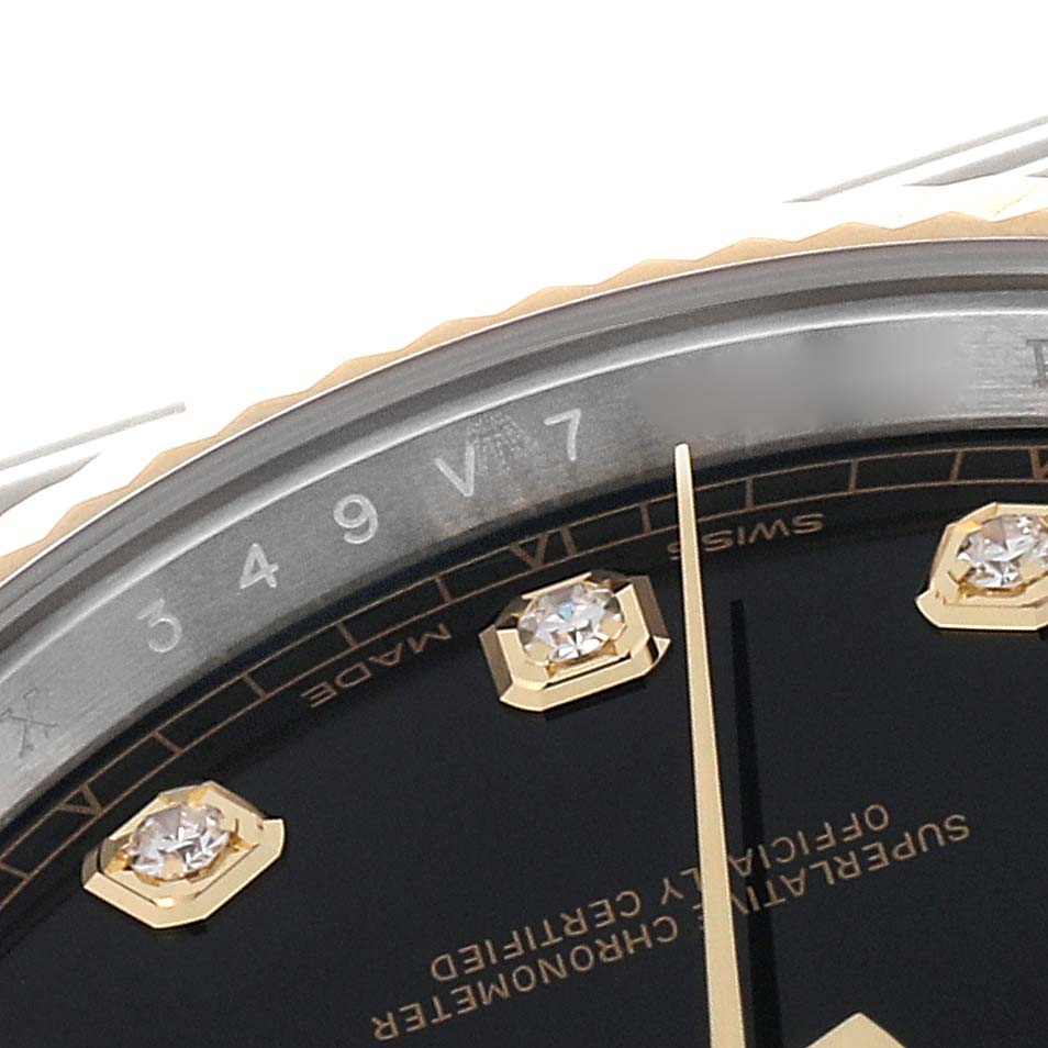 This image shows a close-up angle of the dial and bezel of the Rolex Datejust 41 126333 Men's Steel and Gold (two tone) Black Dial 126333 Men's Steel and Gold (two tone) Black Dial watch, highlighting its markers and text.