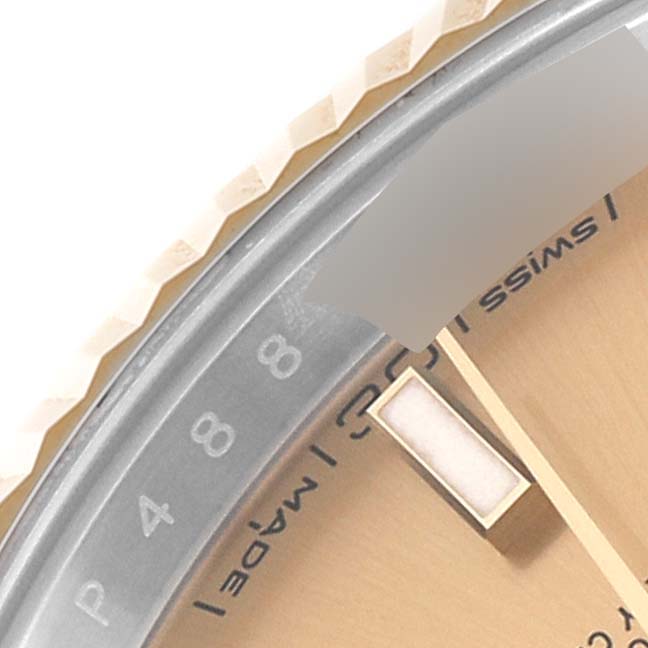 The image shows a close-up of the bezel, part of the dial, and part of the hour hand of the Rolex Datejust 41 126333 Men's Steel and Gold (two tone) Champagne Dial 126333 Men's Steel and Gold (two tone) Champagne Dial watch.