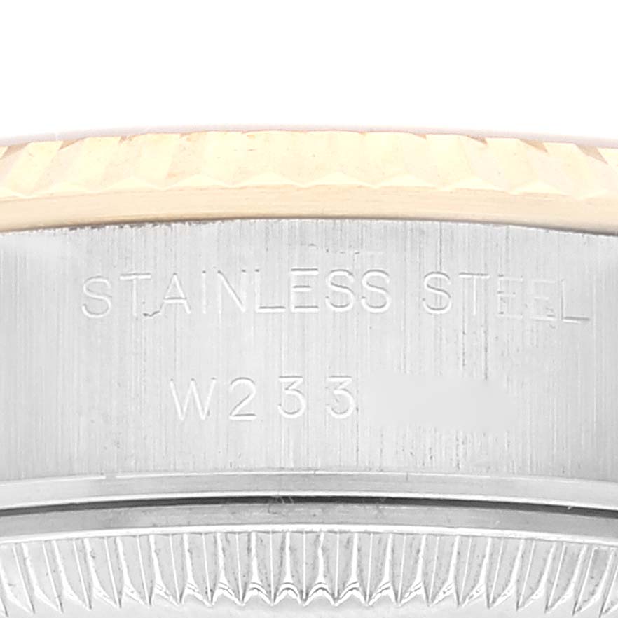This image shows a close-up of the case side and bezel of a Rolex Datejust 69173 Women's Steel and Gold (two tone) Champagne Dial 69173 Women's Steel and Gold (two tone) Champagne Dial watch, highlighting the stainless steel engraving.