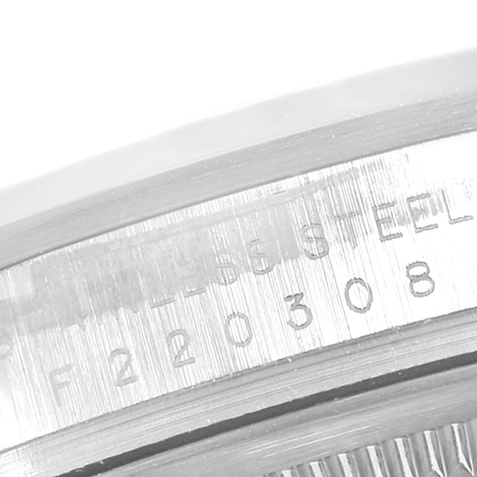 This close-up shows the side of a Rolex Explorer 114270 Men
s Stainless Steel Black Dial 114270 Men
s Stainless Steel Black Dial model watch with engraved details on the case.