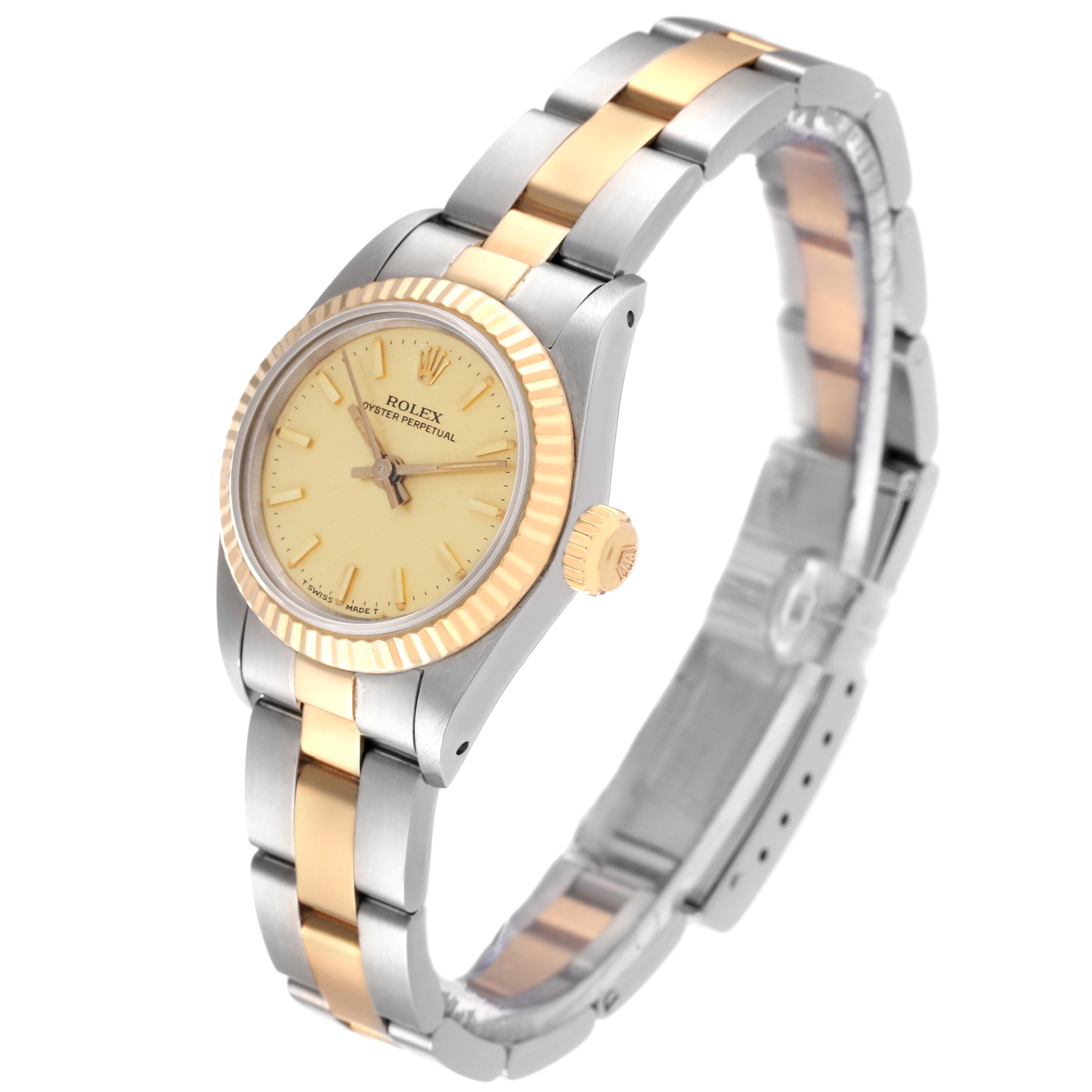 The Rolex Oyster Perpetual 67193 Women's Steel and Gold (two tone) Champagne Dial 67193 Women's Steel and Gold (two tone) Champagne Dial watch is shown at a slight angle, displaying its face, bezel, crown, and bracelet.
