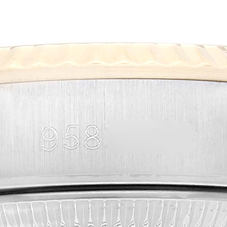 This image shows a close-up of the engraved serial number on the side of a Rolex Oyster Perpetual 67193 Women's Steel and Gold (two tone) Champagne Dial 67193 Women's Steel and Gold (two tone) Champagne Dial watch.