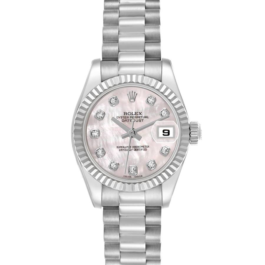 The Rolex President model watch is shown from a top-down angle, displaying the dial, bezel, and bracelet clearly.