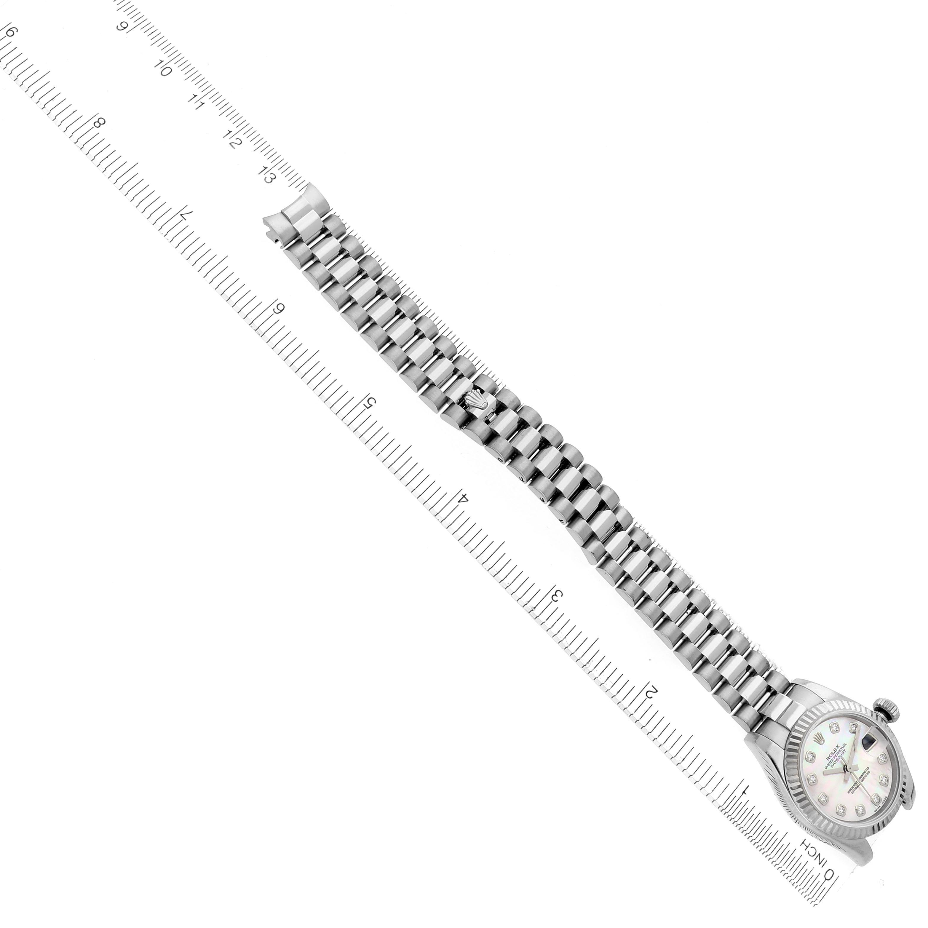 The Rolex President 179179 Women's White Gold Mother of Pearl Dial 179179 Women's White Gold Mother of Pearl Dial model is shown from an overhead angle, displaying the full bracelet and watch face aligned with a ruler.