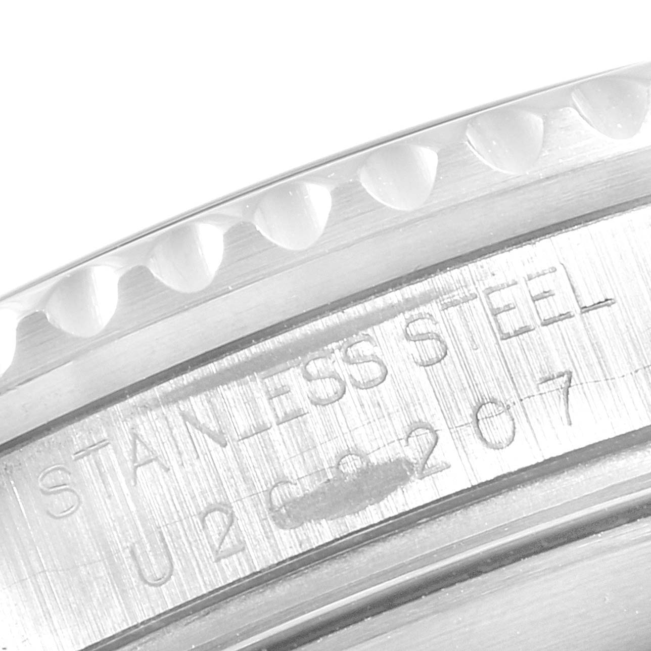 The image shows an extreme close-up of the engraved 
STAINLESS STEEL
 and a partial serial number on the case of a Rolex Submariner 16610 Men
s Stainless Steel Black Dial 16610 Men
s Stainless Steel Black Dial watch.