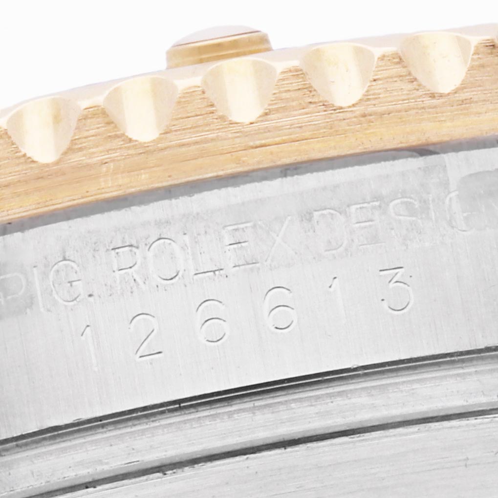 The image shows a close-up angle of the bezel and engraved edge of a Rolex Submariner 126613 Men
s Steel and Gold (two tone) Blue Dial 126613 Men
s Steel and Gold (two tone) Blue Dial, highlighting the model number.