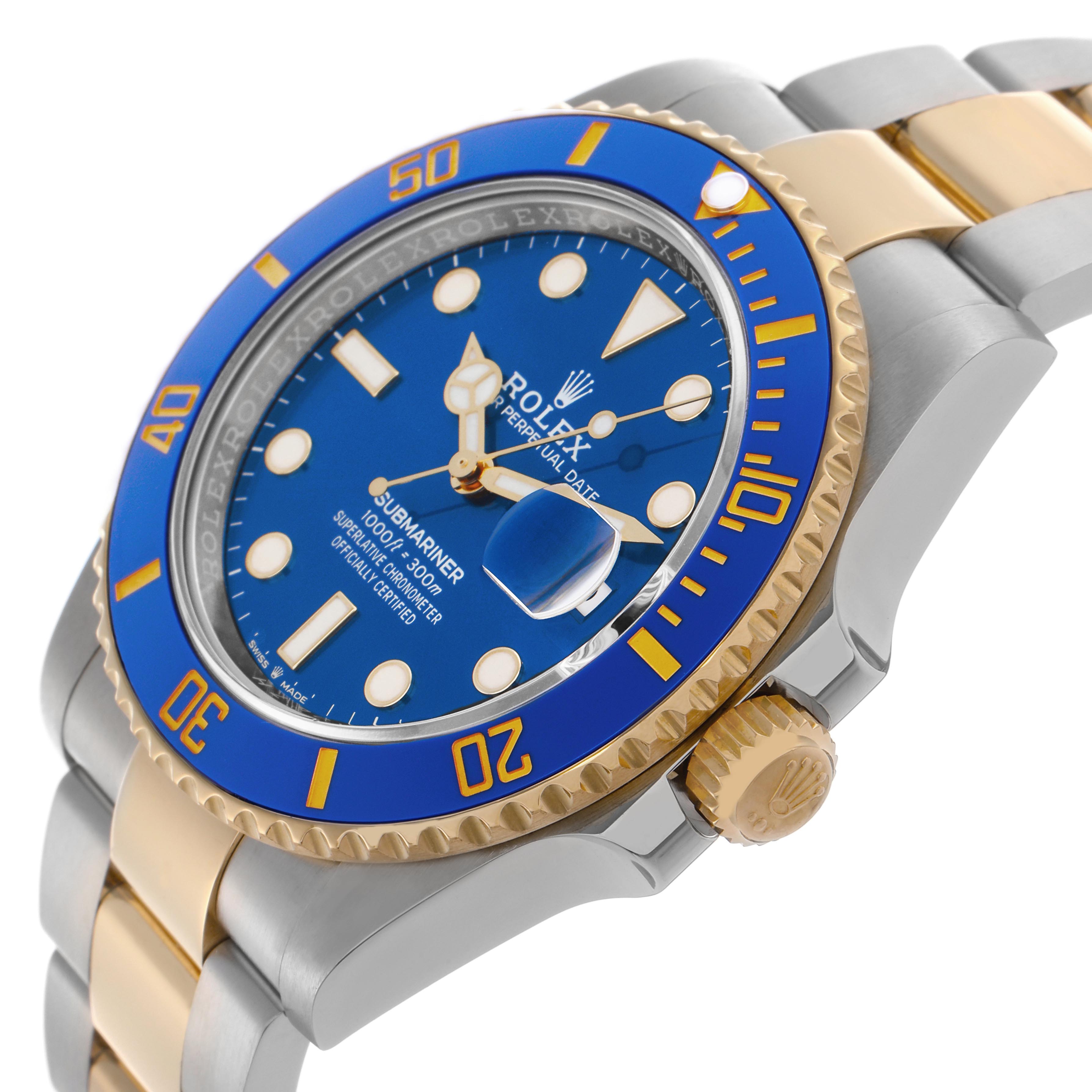 The Rolex Submariner 126613 Men
s Steel and Gold (two tone) Blue Dial 126613 Men
s Steel and Gold (two tone) Blue Dial is shown at a three-quarter angle, highlighting its blue bezel, gold crown, and two-tone bracelet.