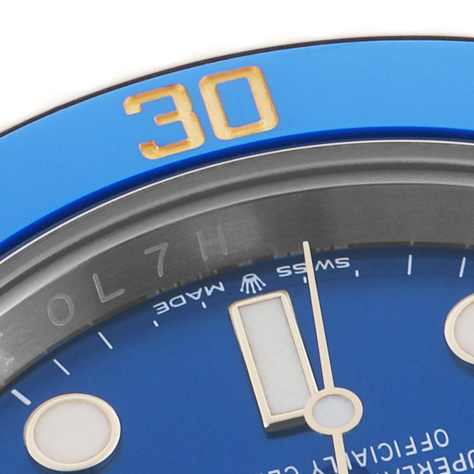 The image shows a close-up of the Rolex Submariner 126613 Men
s Steel and Gold (two tone) Blue Dial 126613 Men
s Steel and Gold (two tone) Blue Dial
s bezel and part of the dial, highlighting the "30" marker and hands.