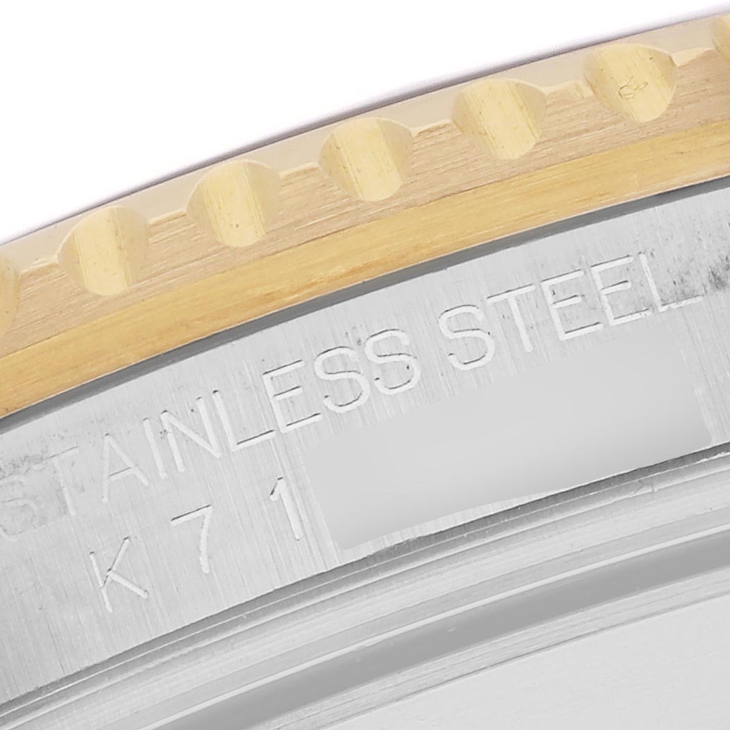 The image shows the edge of the bezel and engravings on the side of the Rolex Submariner 16613 Men
s Steel and Gold (two tone) Champagne Dial 16613 Men
s Steel and Gold (two tone) Champagne Dial watch.