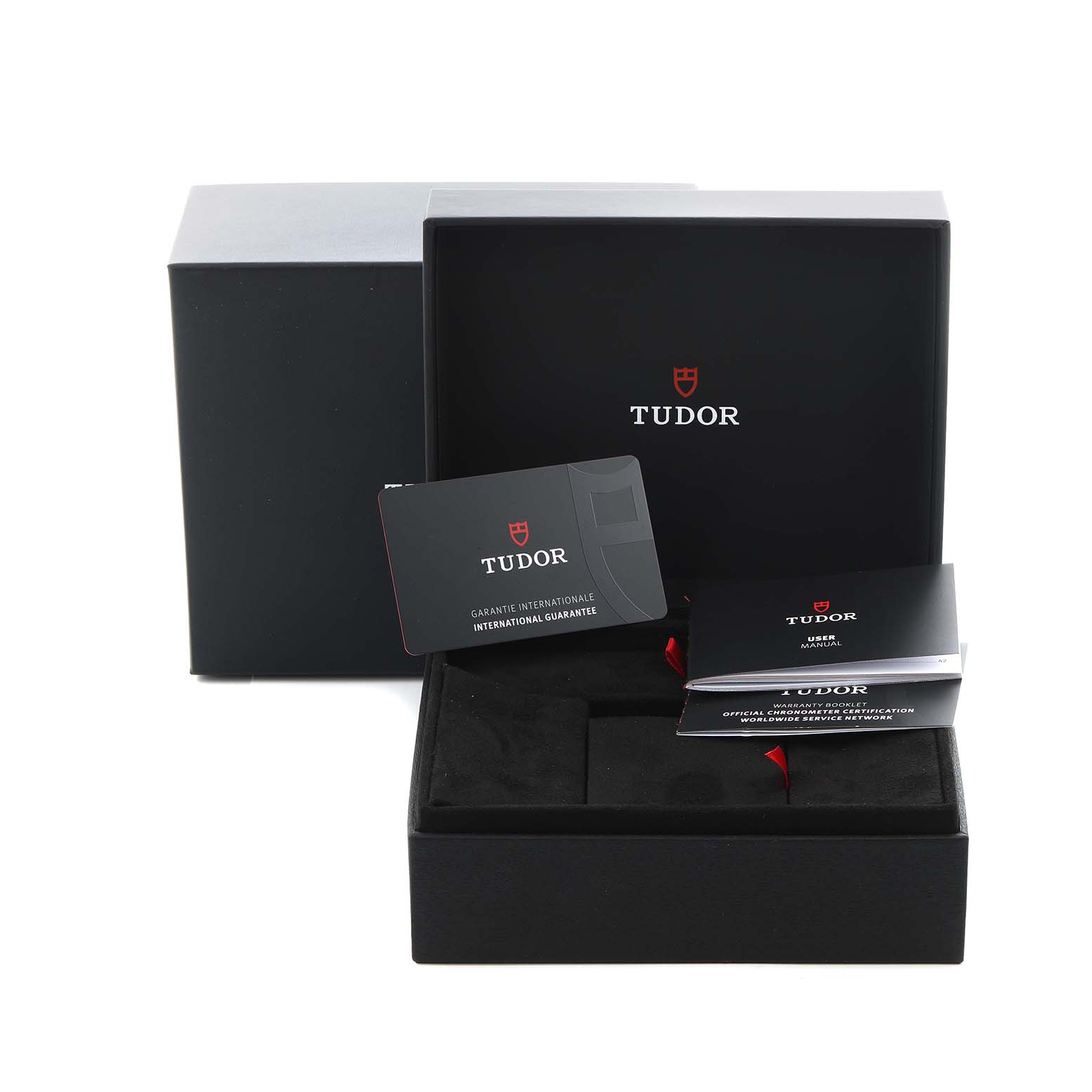 The image shows the packaging and accessories for the Tudor Heritage Black Bay 79000N-0001 Men
s Stainless Steel Black Dial 79000N-0001 Men
s Stainless Steel Black Dial, including a box, warranty card, and manual.