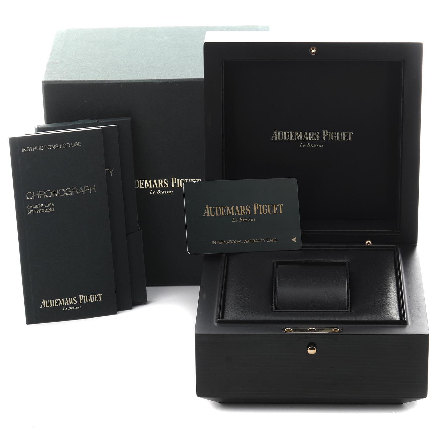 The image shows packaging and accessories for the Royal Oak Offshore by Audemars Piguet including a box, manuals, and warranty card.