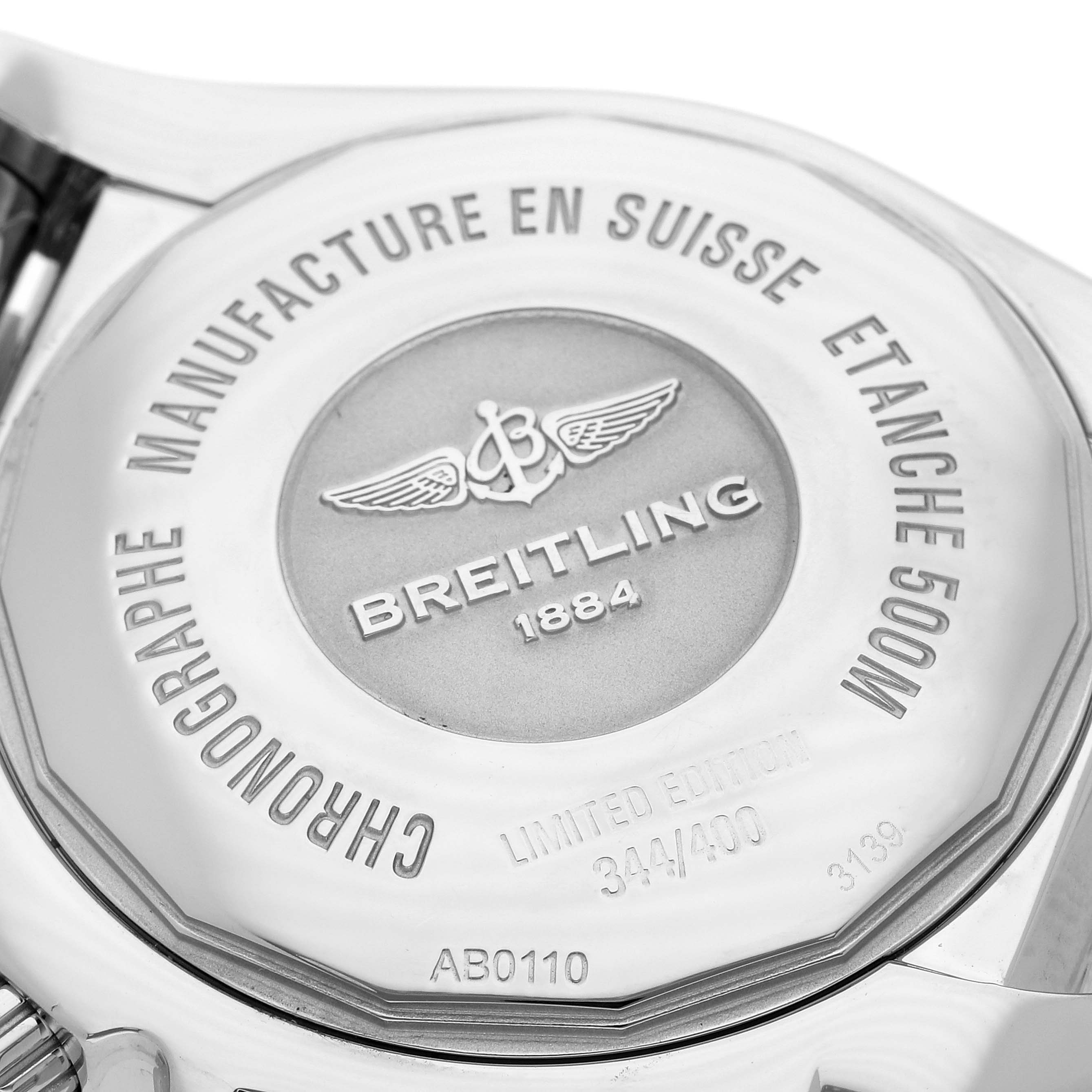 The image shows the case back of a Breitling Chronomat AB0110 Men
s Stainless Steel Mother of Pearl Dial AB0110 Men
s Stainless Steel Mother of Pearl Dial watch, highlighting the brand logo and inscriptions.
