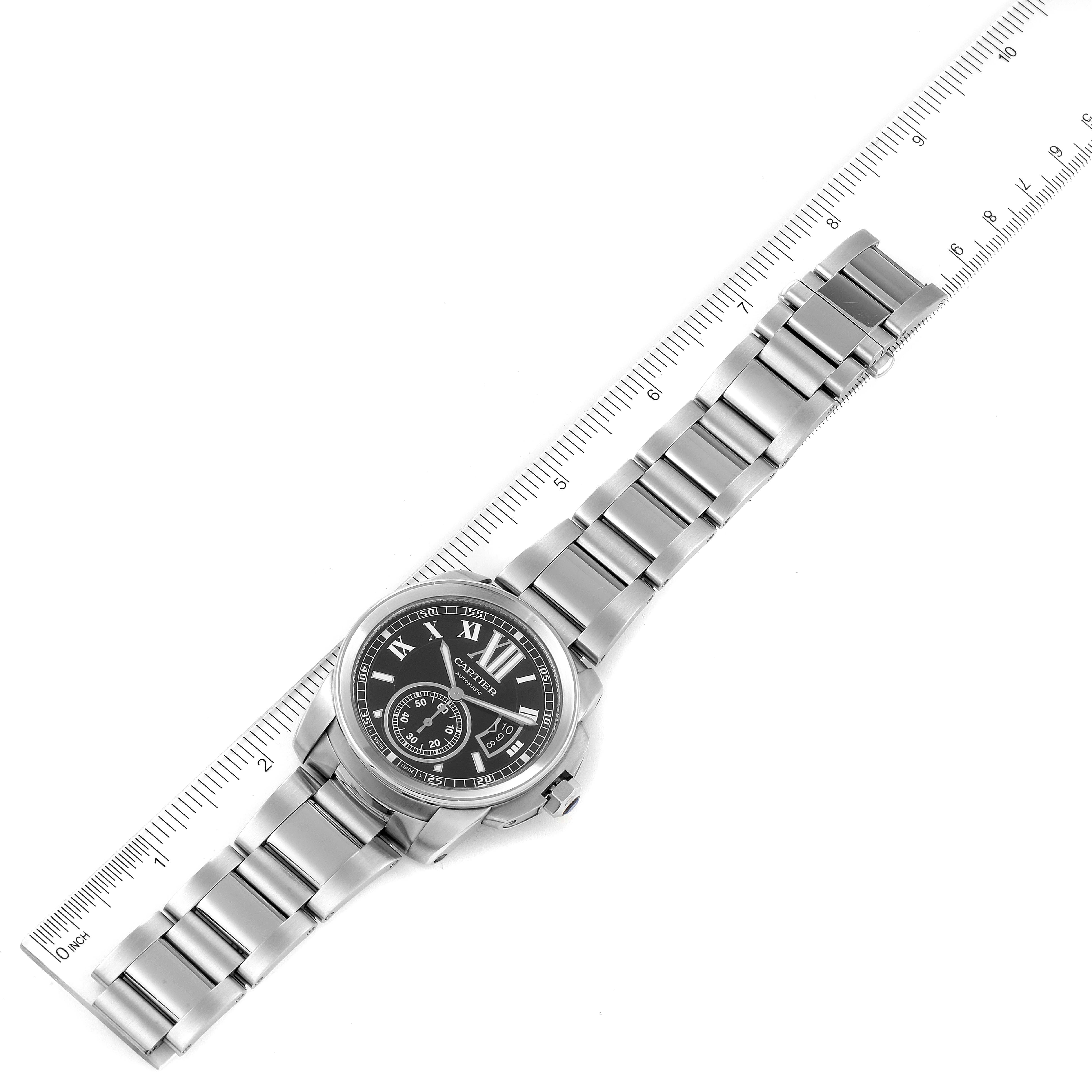 The image shows a top-down view of the Calibre de Cartier watch by Cartier, displaying the watch face and metal bracelet.