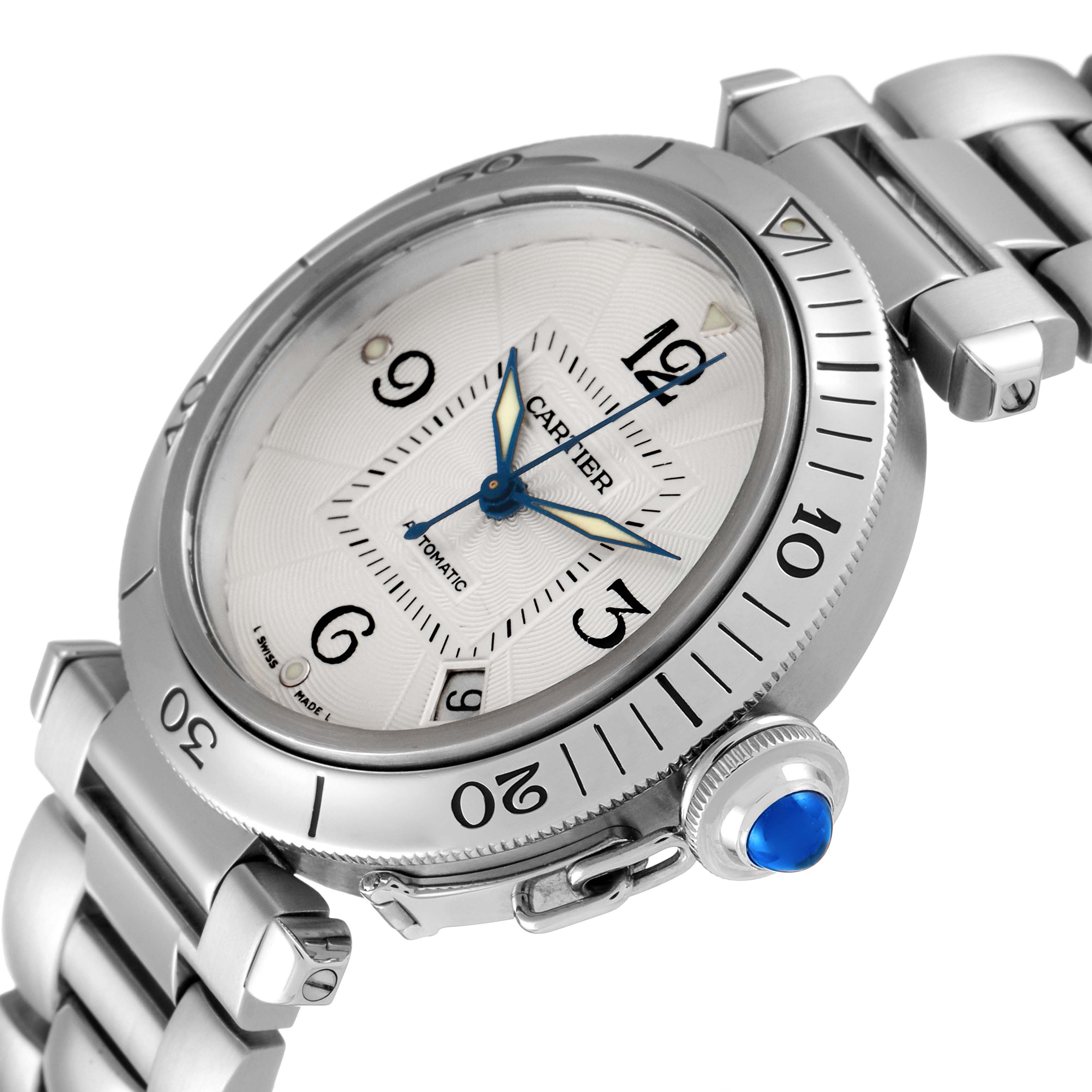 The image shows a close-up angled view of the Cartier Pasha W31040H3 Men
s Stainless Steel Silver Dial W31040H3 Men
s Stainless Steel Silver Dial watch, highlighting its bezel, dial, and crown with a blue cabochon.