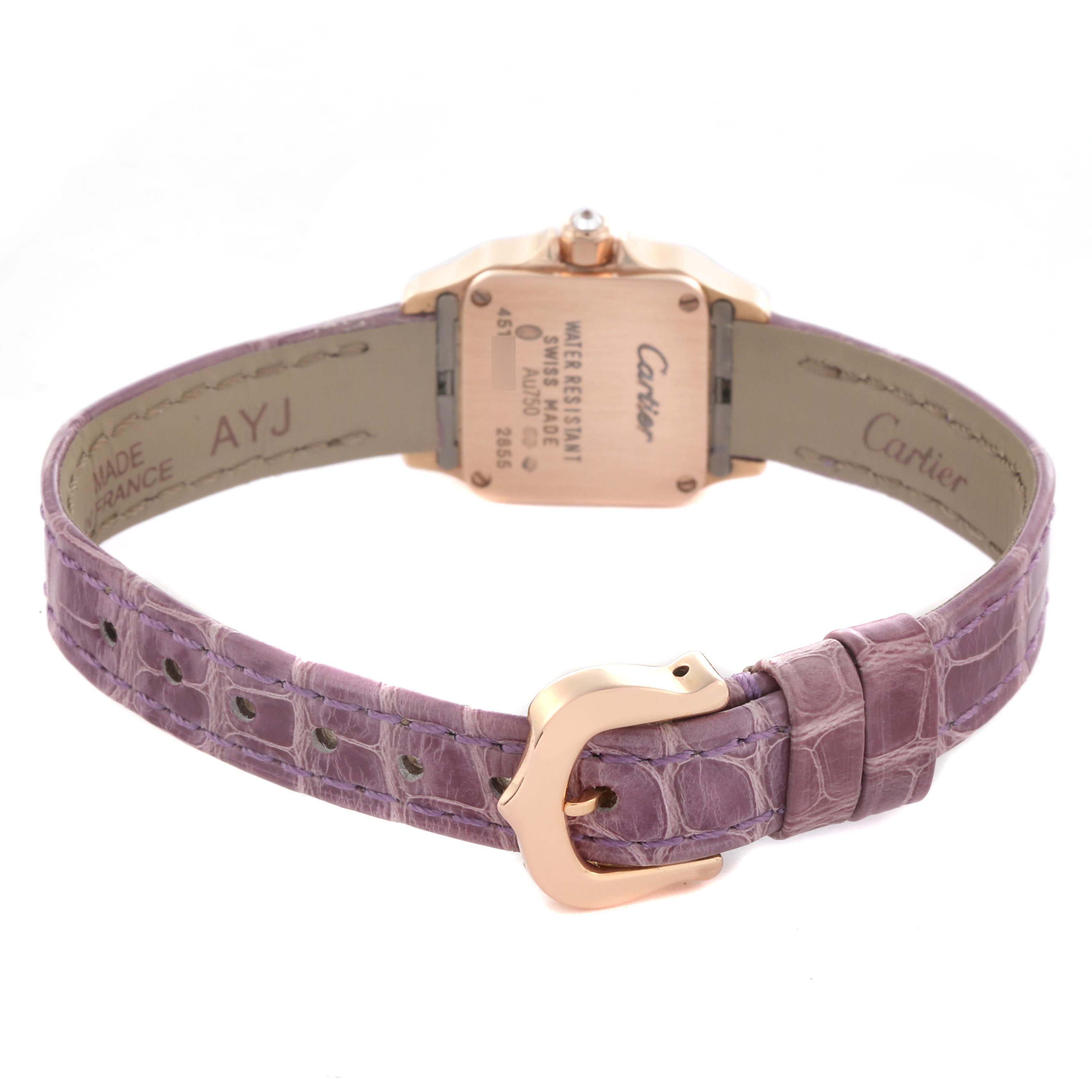 The Cartier Santos Demoiselle WF902004 Women
s Yellow Gold Silver Dial WF902004 Women
s Yellow Gold Silver Dial watch is shown from the back, displaying the case back, crown, and purple strap with a buckle.