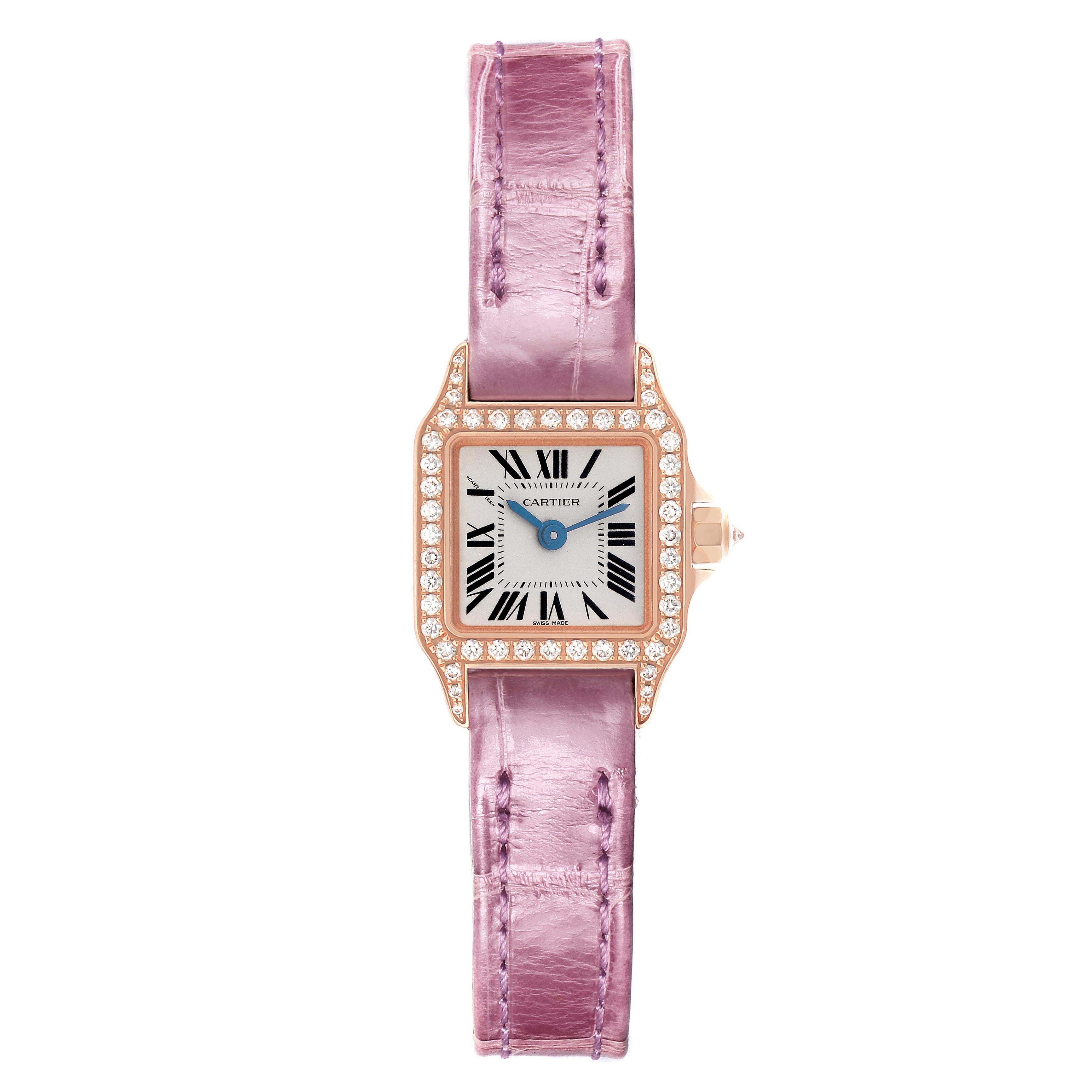 The Cartier Santos Demoiselle WF902004 Women
s Yellow Gold Silver Dial WF902004 Women
s Yellow Gold Silver Dial watch is shown from a top-down angle, displaying its square face, diamond bezel, and lilac strap.