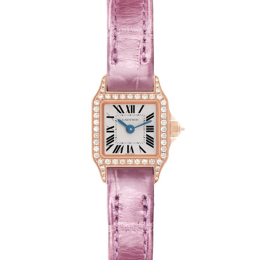 The Cartier Santos Demoiselle watch is shown from a top view, featuring a diamond-encrusted bezel and a pink leather strap.