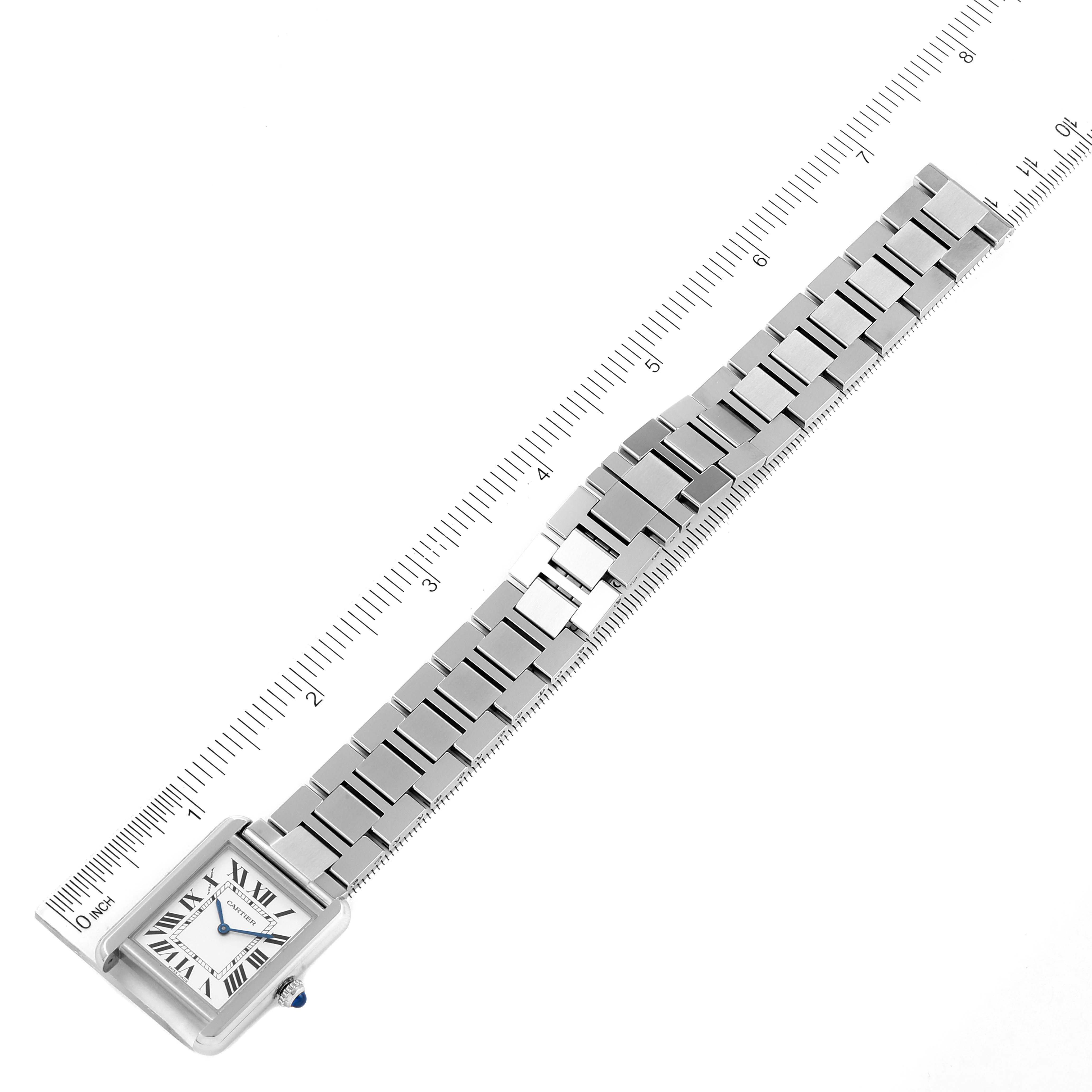 The Cartier Tank Solo W5200013 Women's Stainless Steel Silver Dial W5200013 Women's Stainless Steel Silver Dial watch is shown flat with its face and full stainless steel bracelet aligned against a ruler.