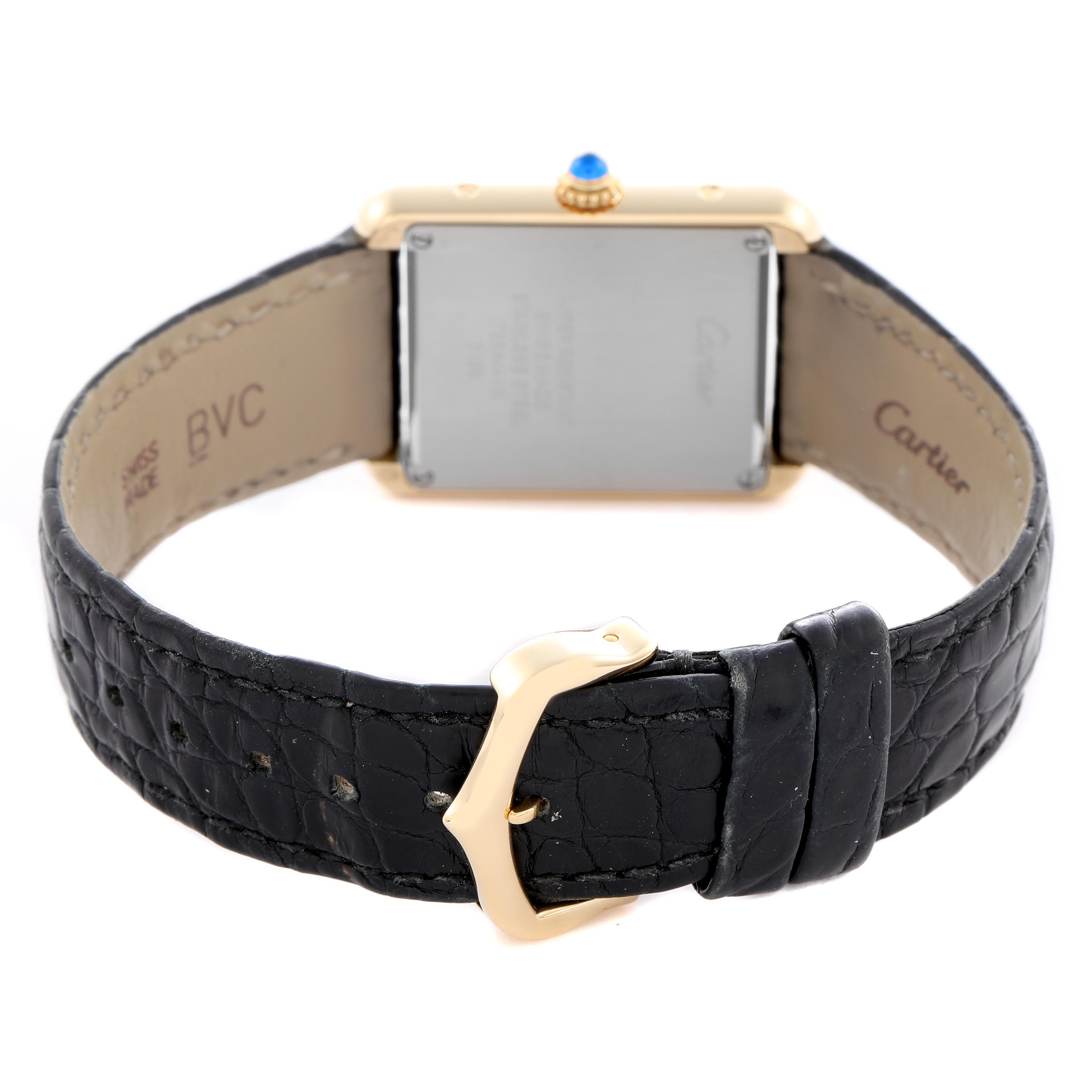 The image shows the back of a Cartier Tank Solo W5200002 Women
s Steel and Gold (two tone) Silver Dial W5200002 Women
s Steel and Gold (two tone) Silver Dial watch, featuring the case, buckle, and black leather strap.