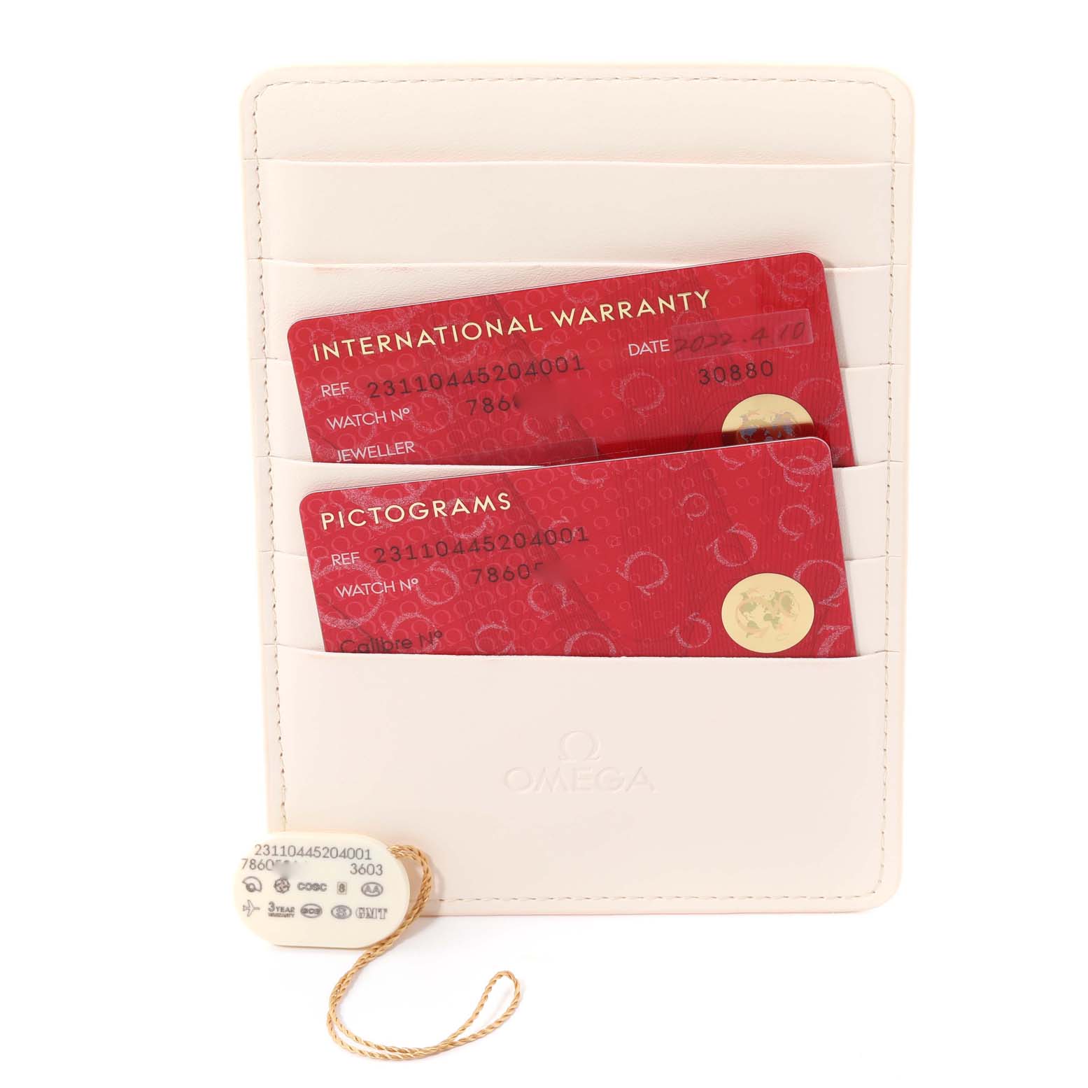 The image shows the international warranty card and pictograms card for the Omega Seamaster 231.10.44.52.04.001 Men
s Stainless Steel White Dial 231.10.44.52.04.001 Men
s Stainless Steel White Dial watch, along with a tag.