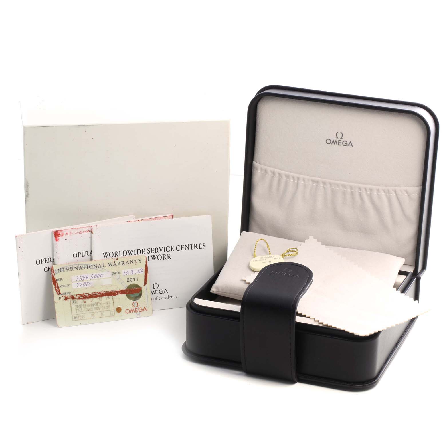 The image shows the packaging and accessories for an Omega Speedmaster 3594.50.00 Men
s Stainless Steel Black Dial 3594.50.00 Men
s Stainless Steel Black Dial, including the box, warranty cards, and a cleaning cloth.