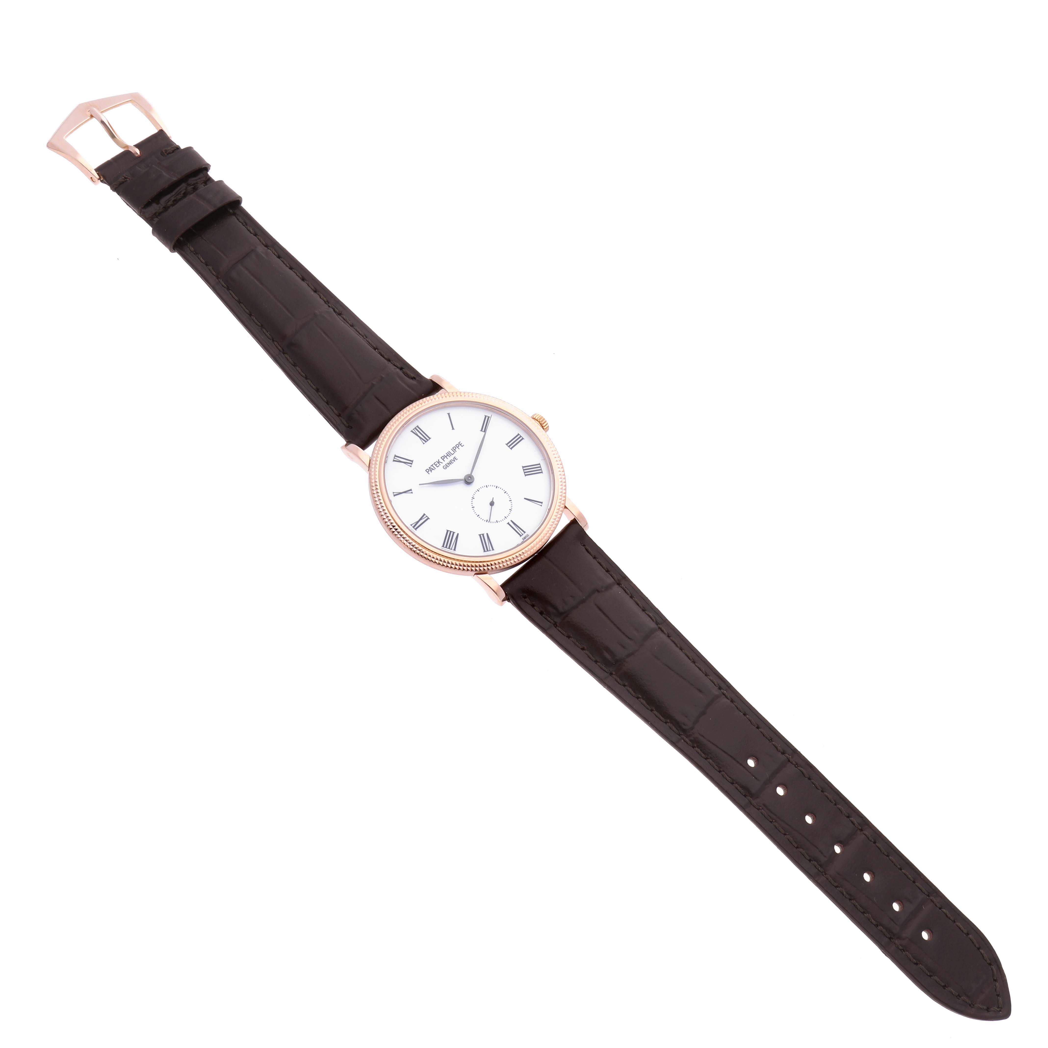 The Patek Philippe Calatrava 5119R-001 Men
s Rose Gold White Dial 5119R-001 Men
s Rose Gold White Dial watch is shown from a top view highlighting the dial, strap, and buckle.